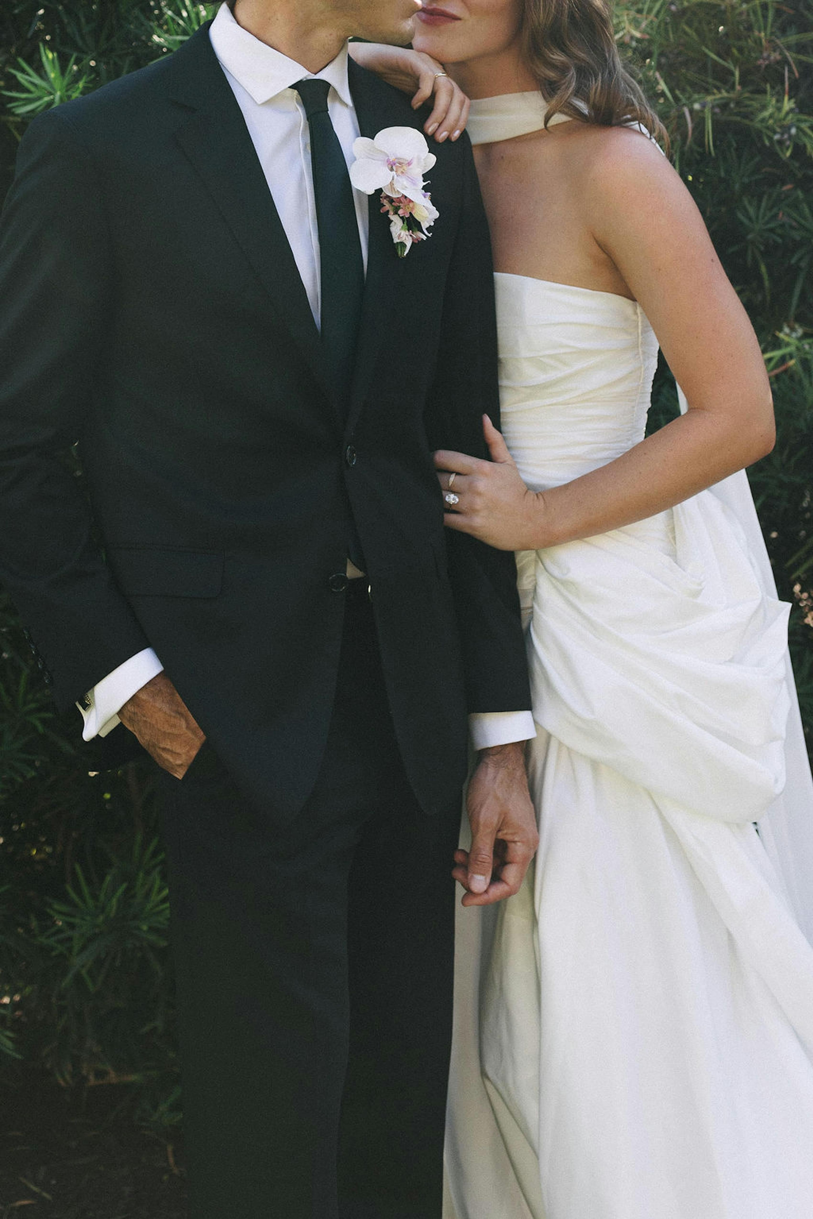 Couple in black tie wedding attire, black suit and tie and long white gown