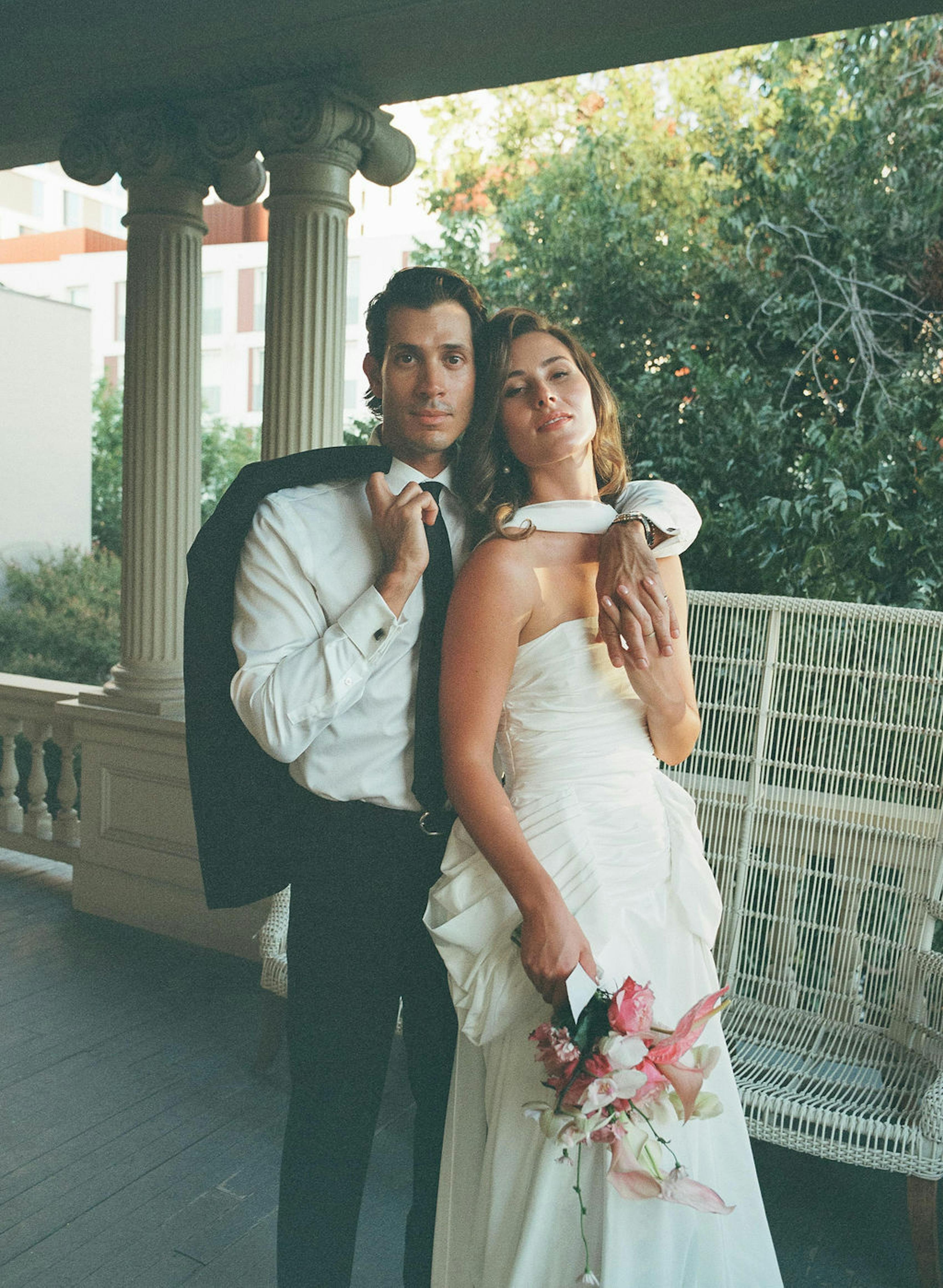 Casual but elegant wedding attire: black suit for groom simple white dress for bride