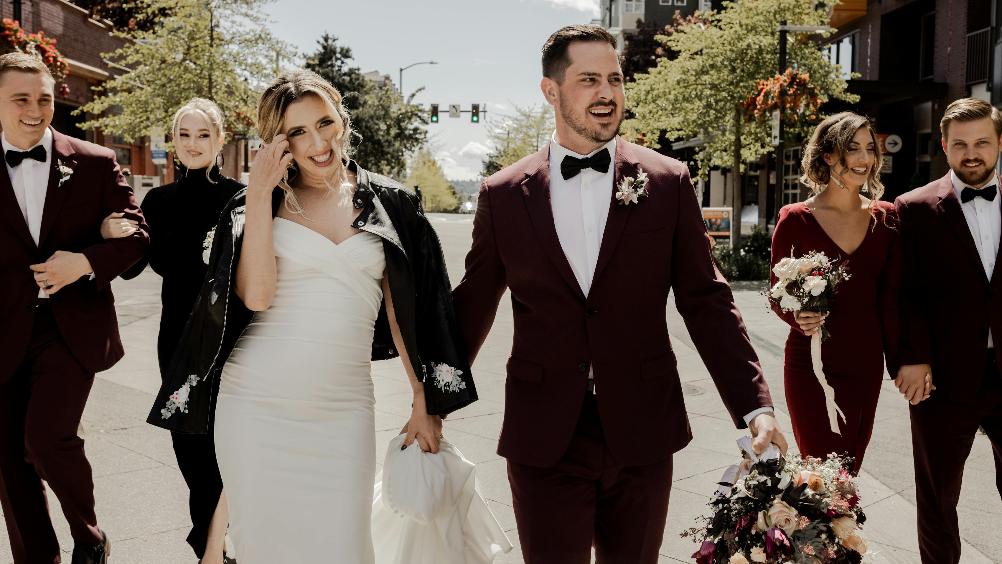 City wedding in maroon groom's suit and burgundy wedding party attire