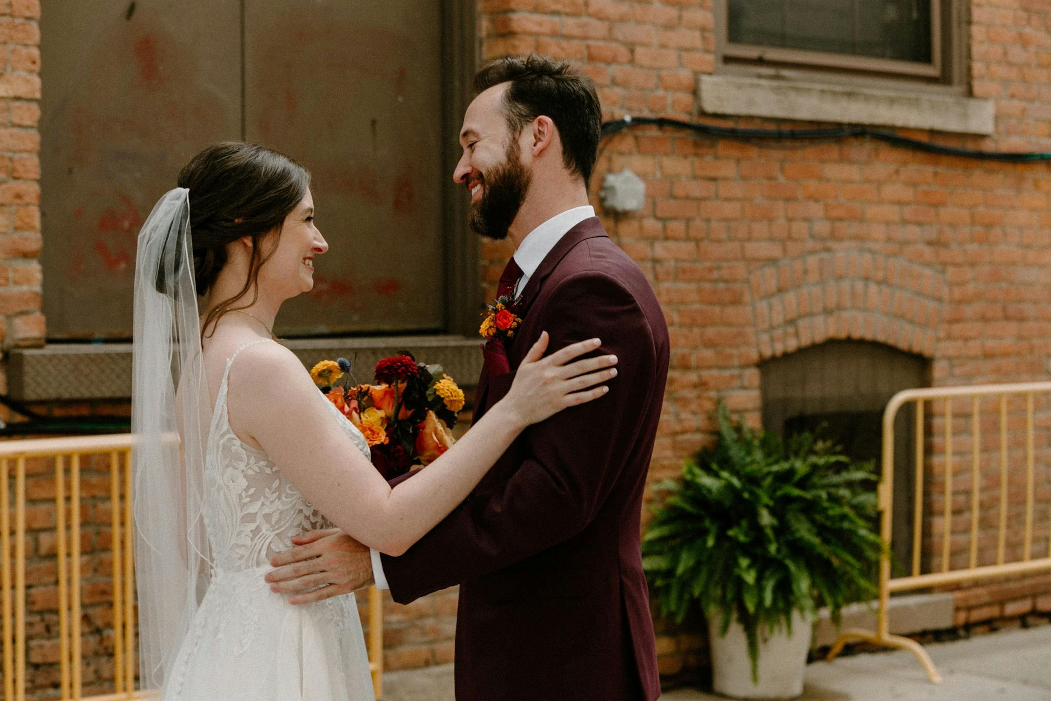 Fall wedding with boho bride and burgundy groom's suit with gold color palette
