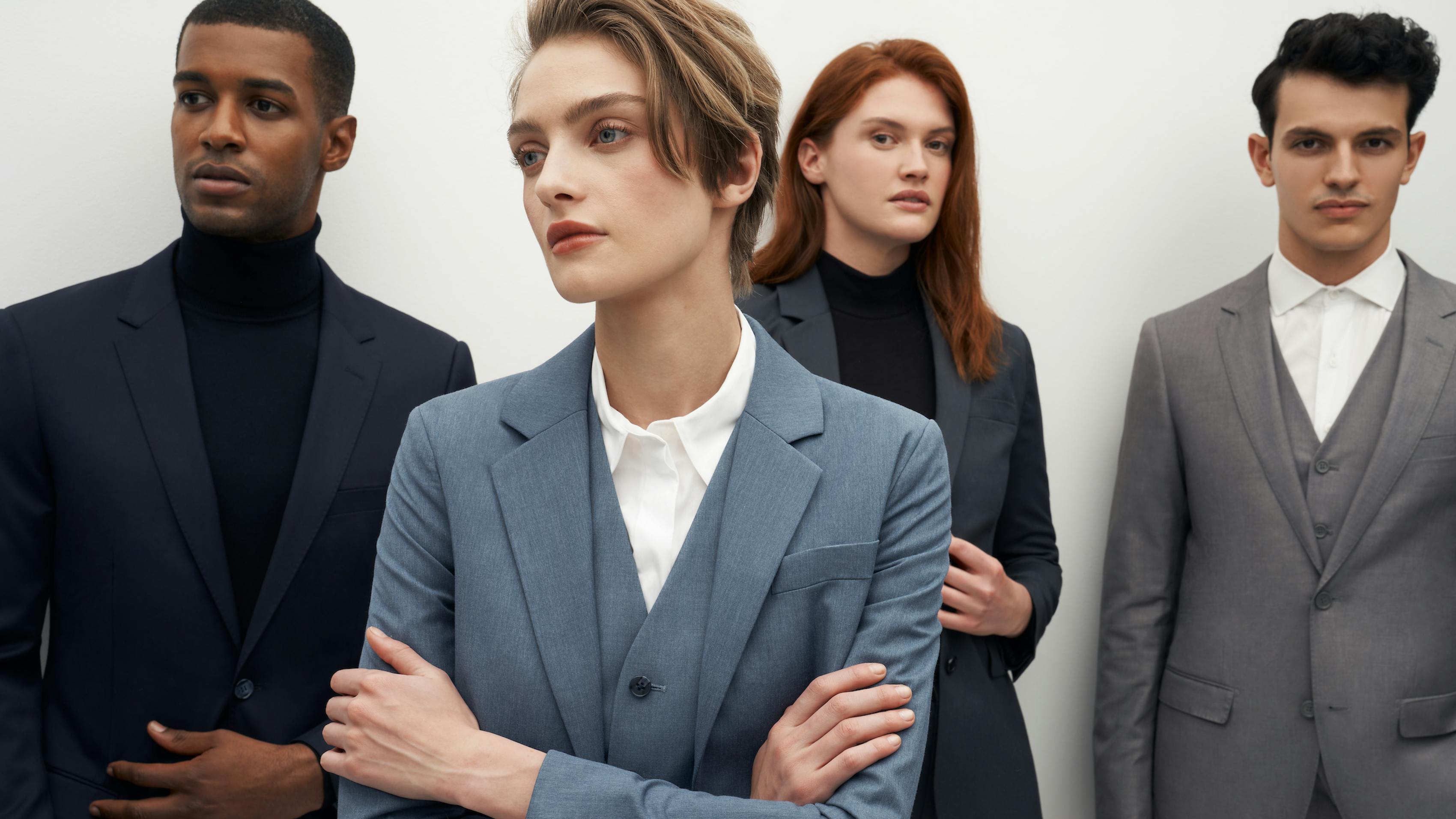 Men's Fitted Suit in Light Grey, Business Casual Suiting Charcoal Grey, Women's Fitted Suit in Light Blue, Women's Business Casual Blazer in Dark Grey