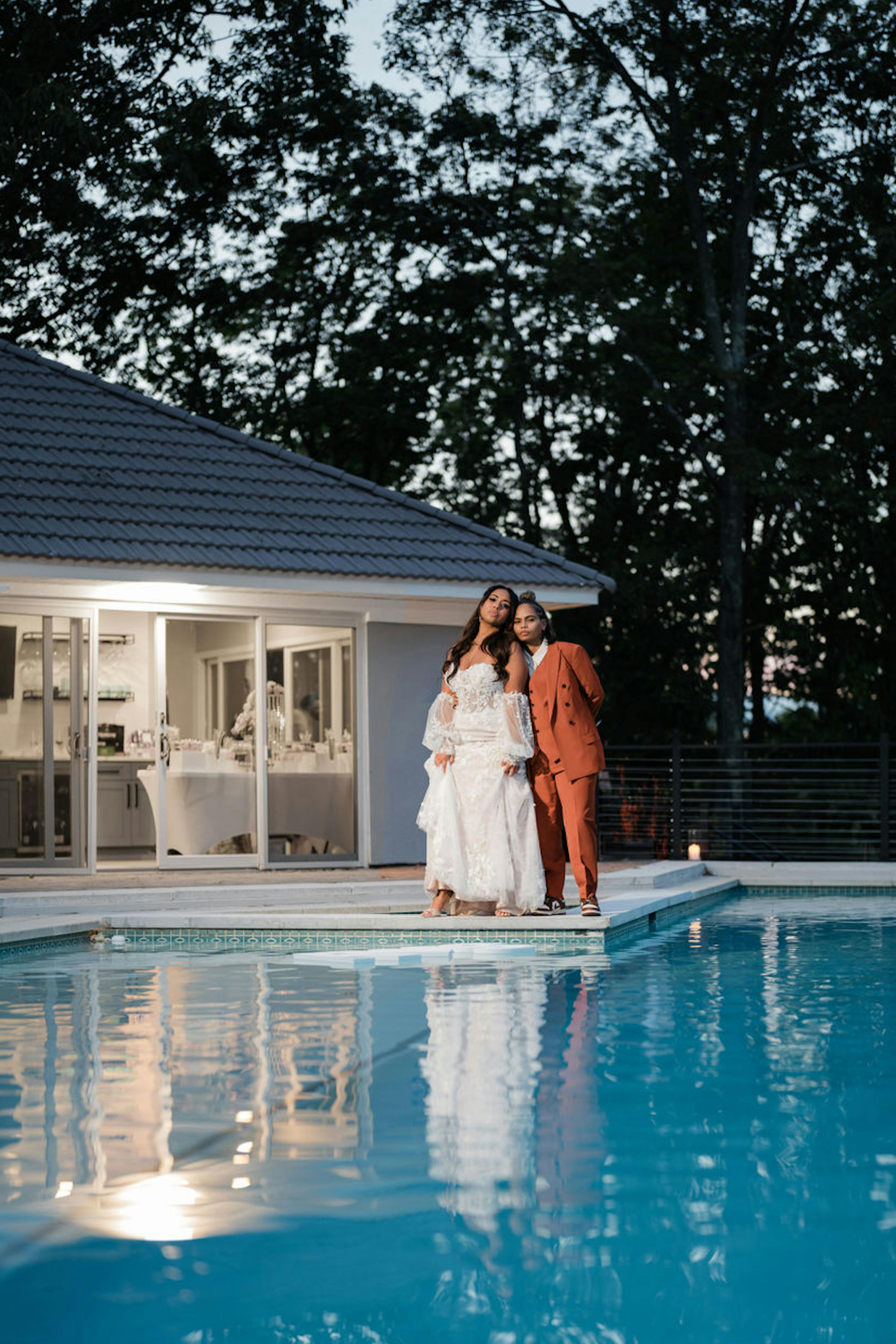 Pool wedding attire with lace wedding dress and burnt orange women's wedding suit