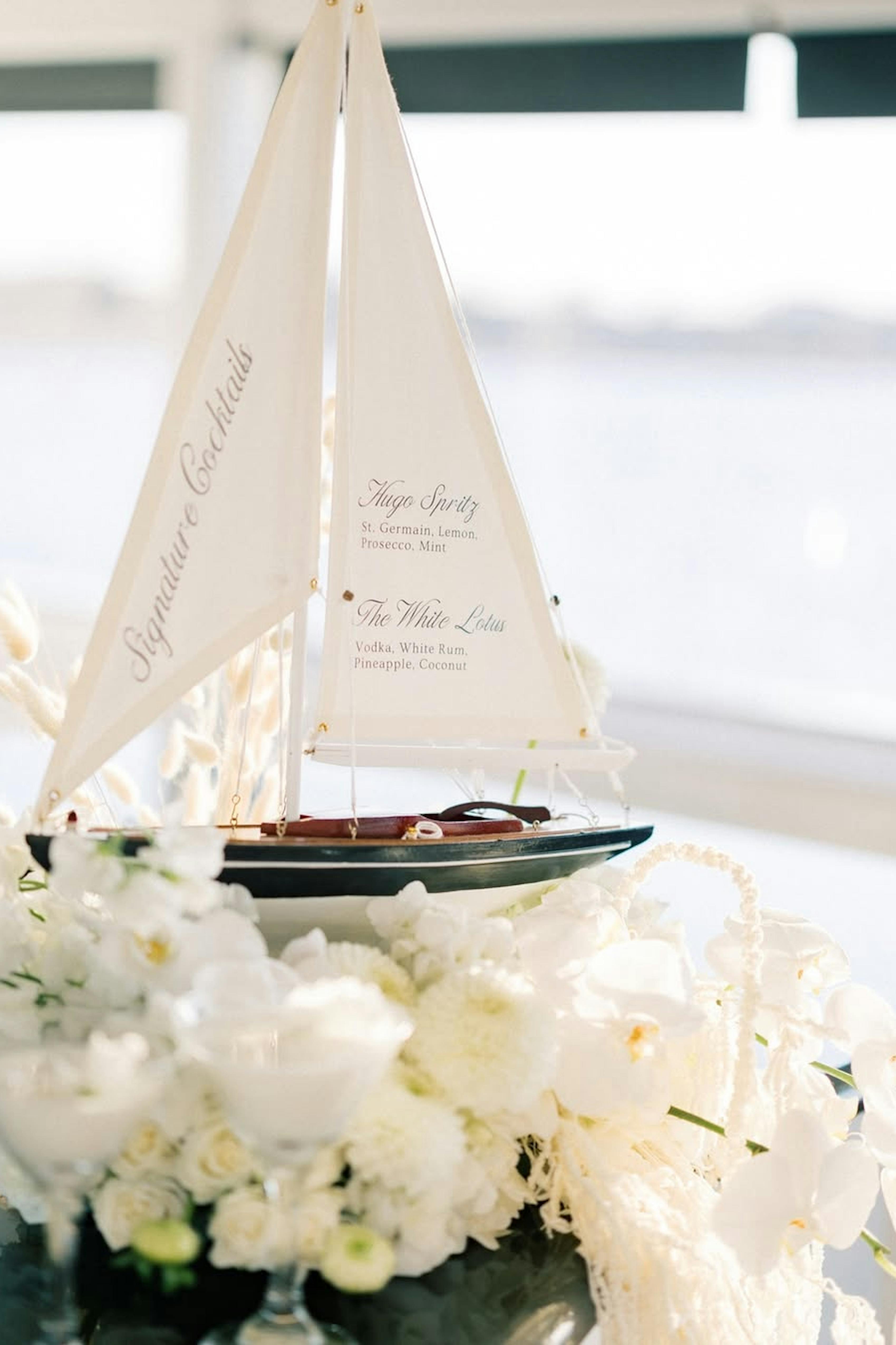 Sailboat themed wedding decor with signature cocktail menu