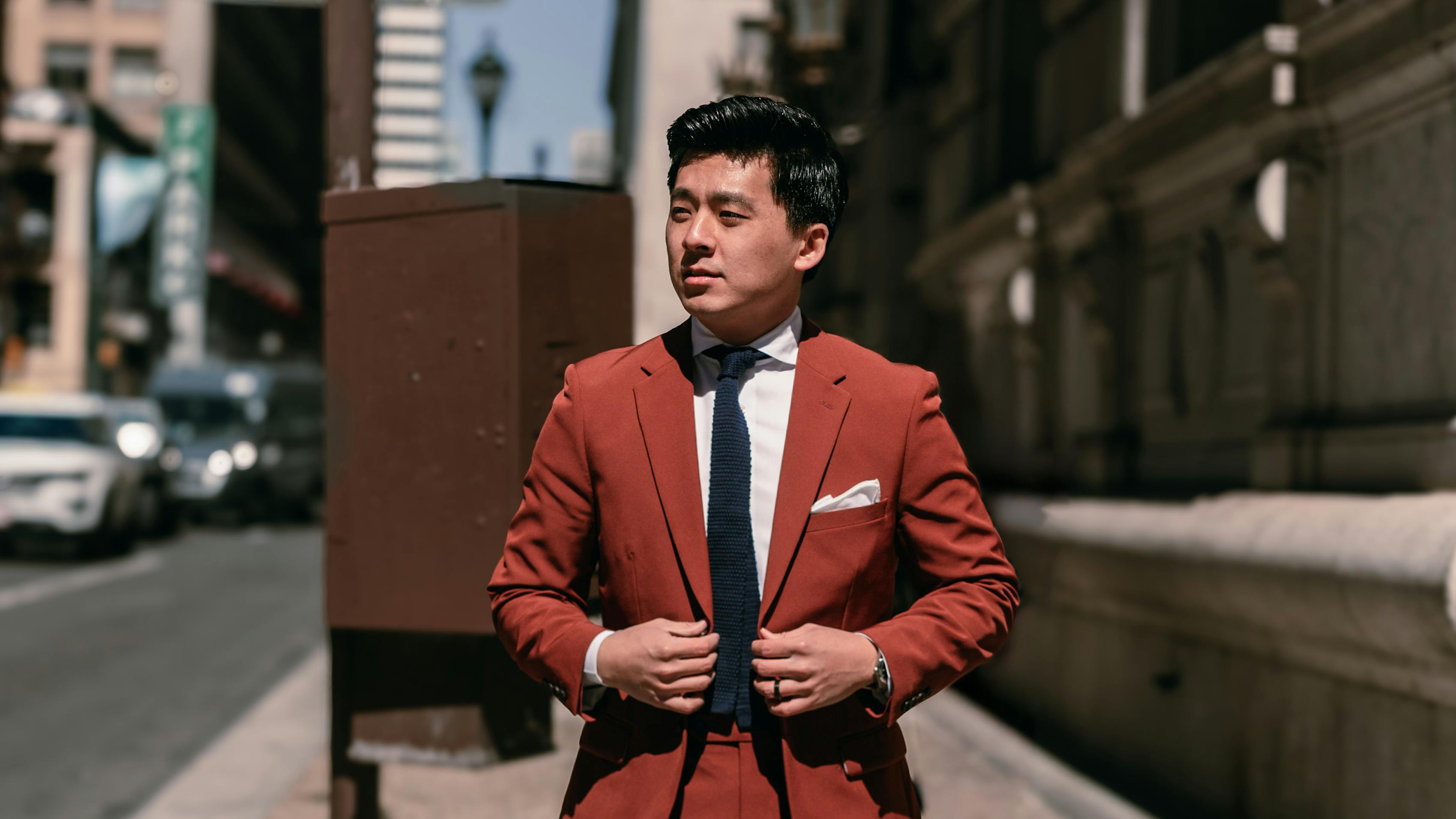 Simple bold men's suit outfit with terracotta clay suit with loafers for city street style