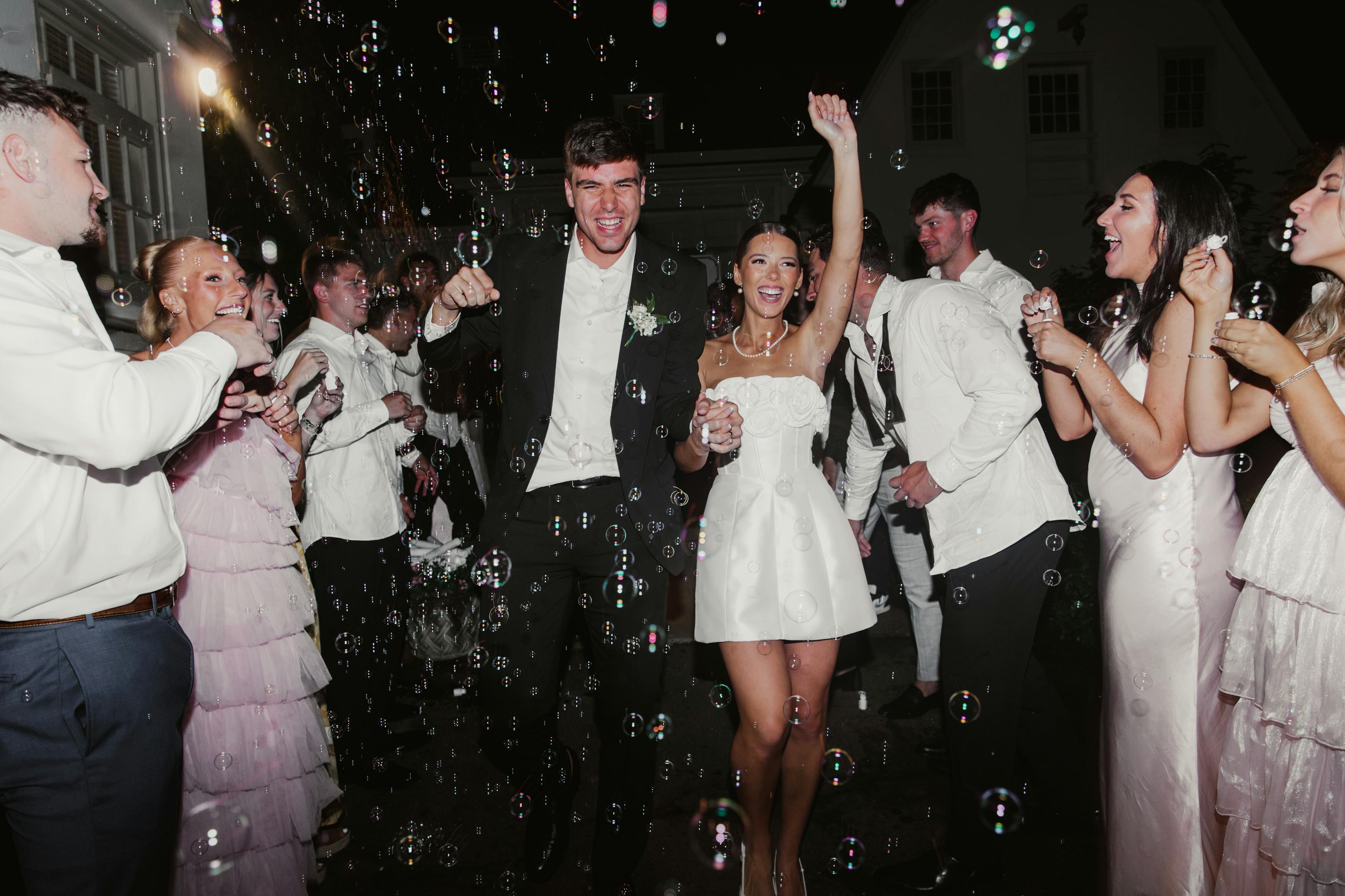 Blush pink, black, and white wedding color palette for guest dress code on dance floor