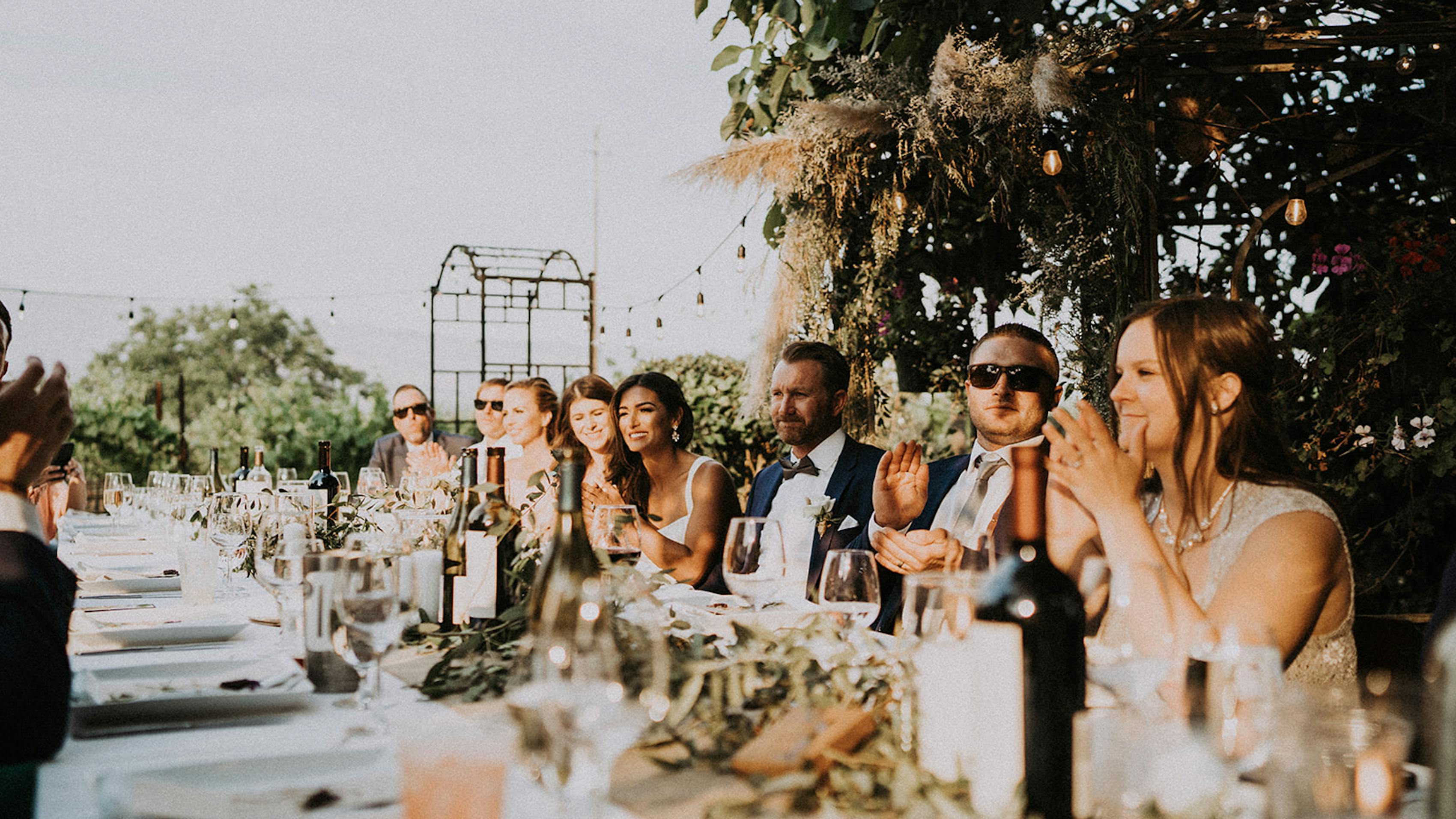 Guests at wedding reception dressed in summer suits and dresses