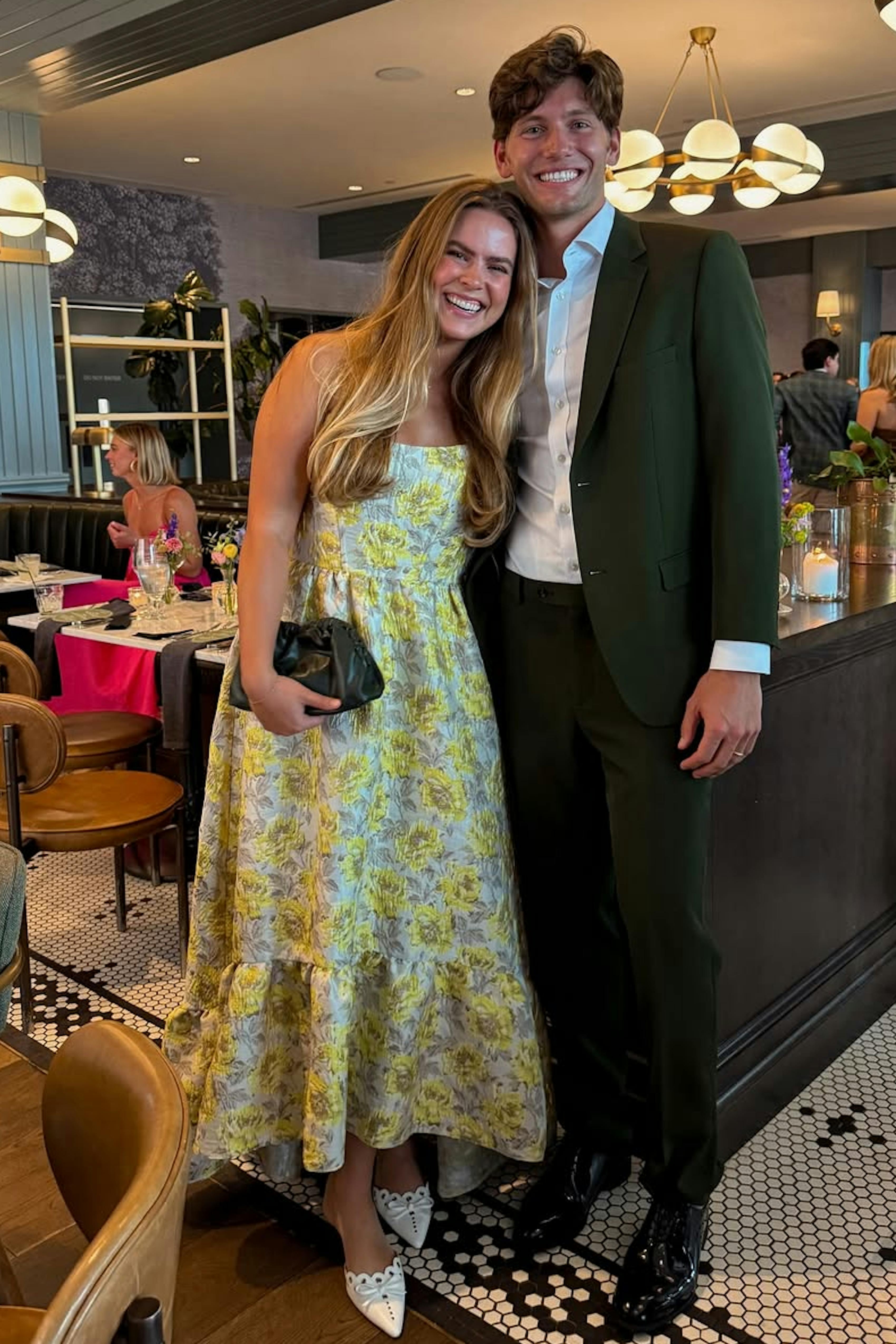 Couple's summer wedding guest outfits in blue tea length dress and green suit