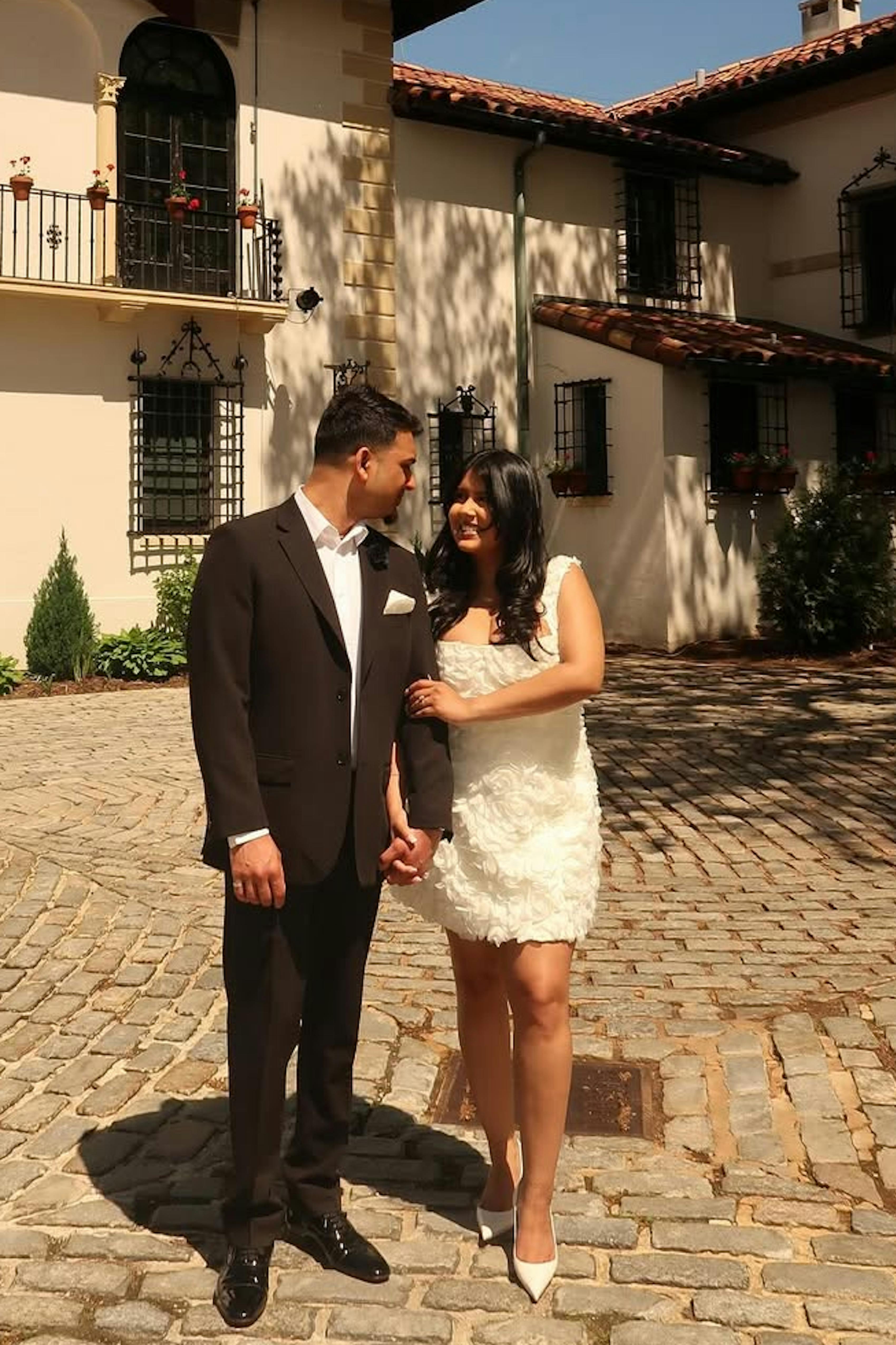 Bride and groom wearing dark brown suit and short wedding dress for fall