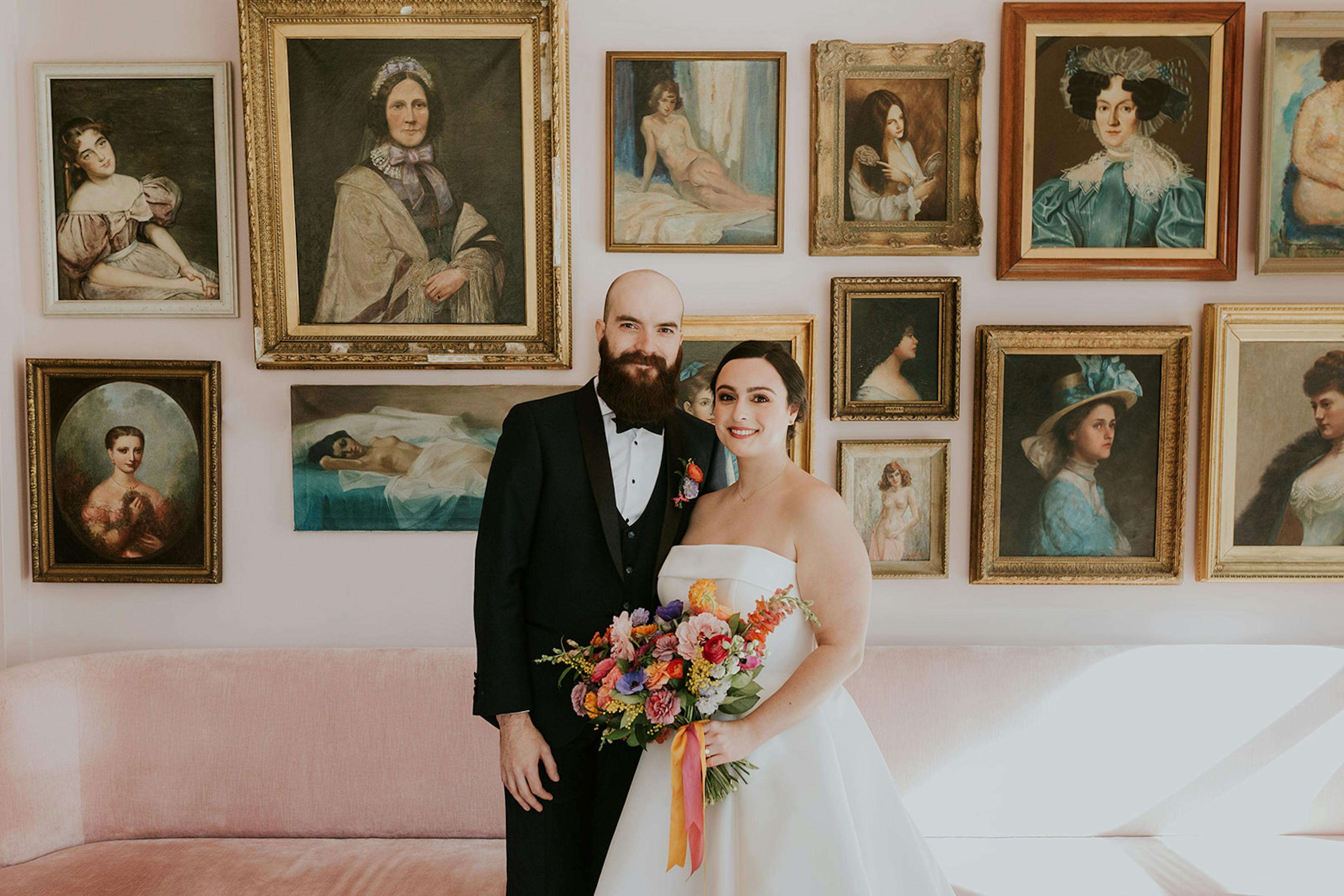 Eclectic vintage wedding decor with portrait gallery wall