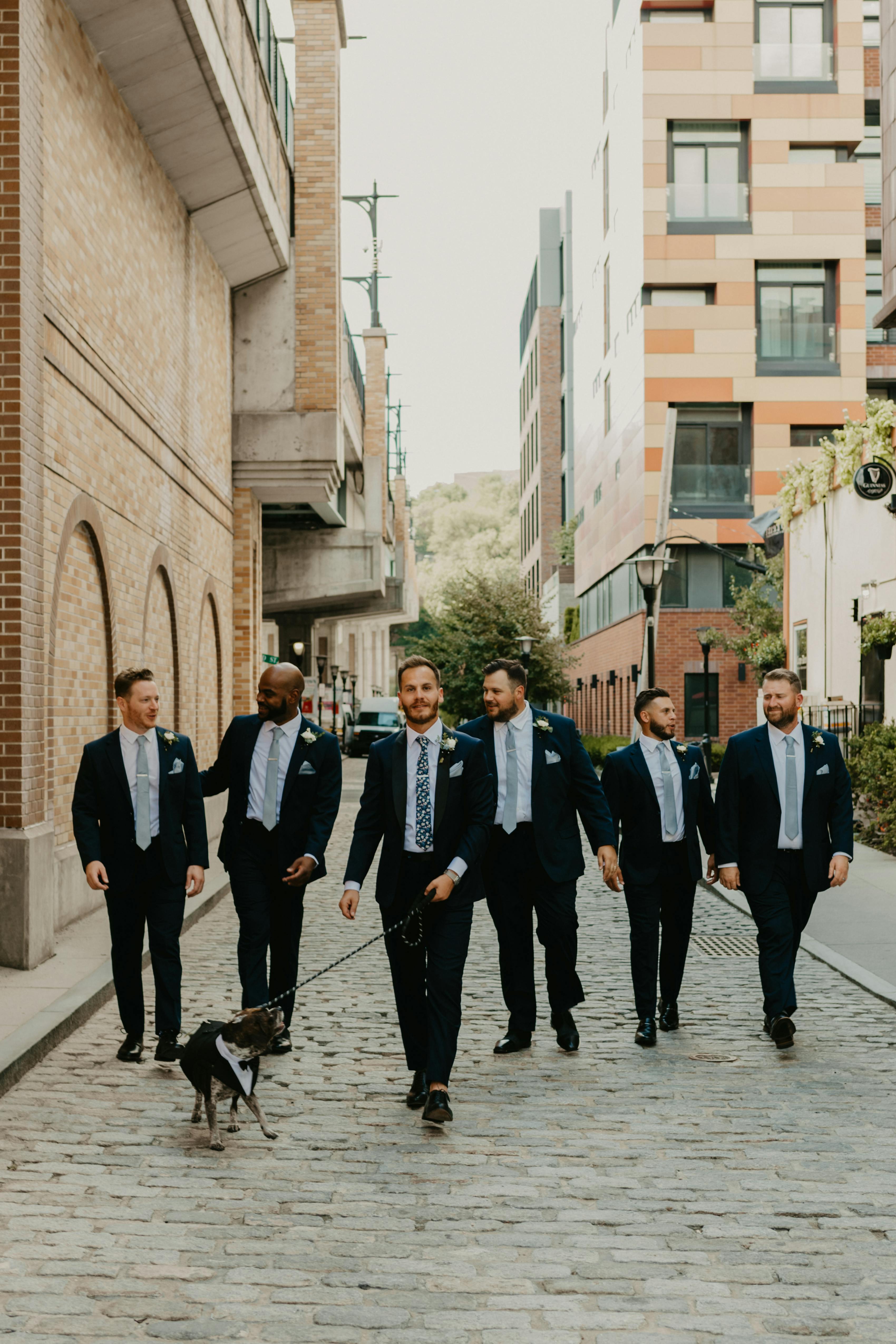Navy groomsman suits with mix and match blue floral ties