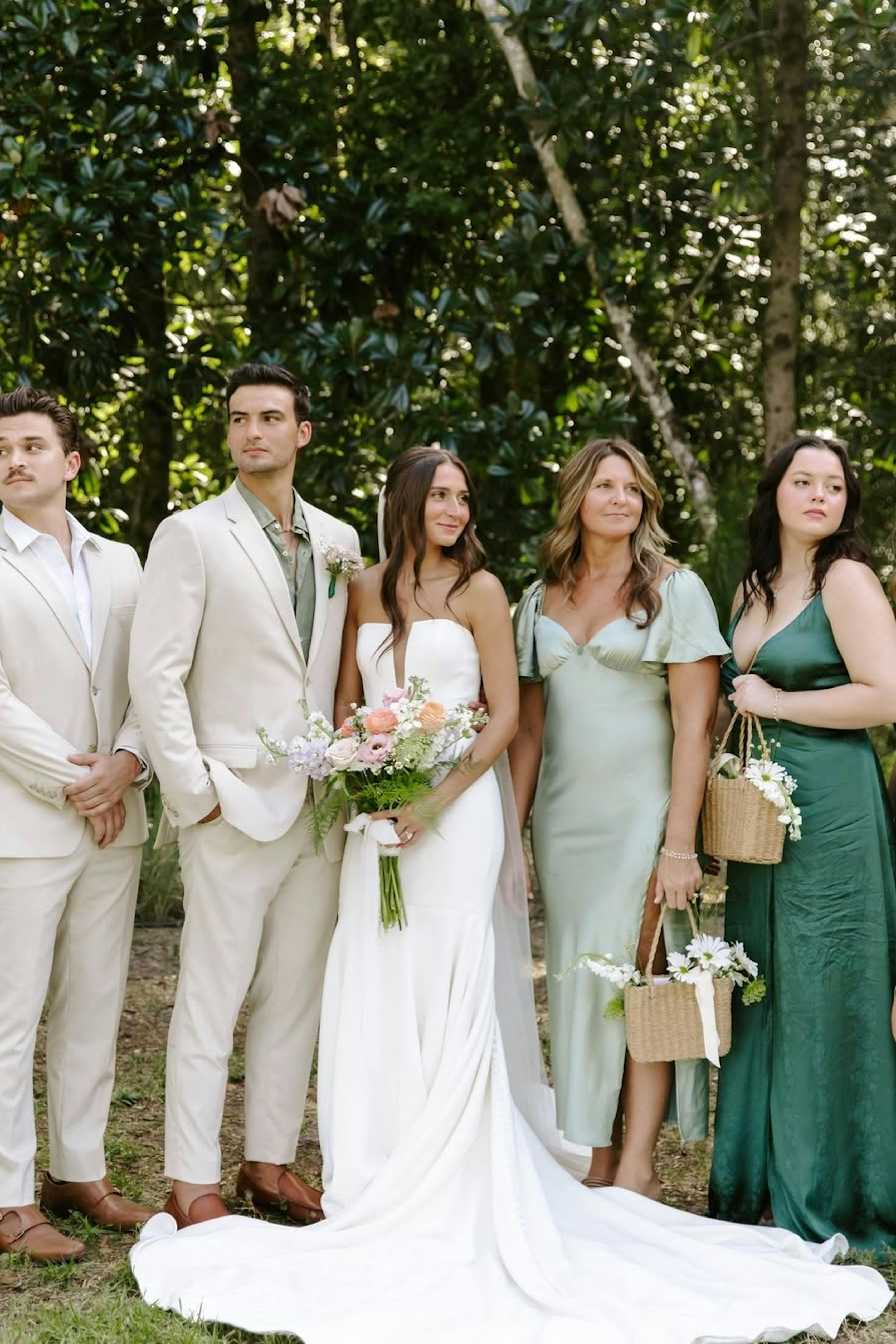 Unique groom style with light tan suit and sage green dress shirt to stand out from groomsmen