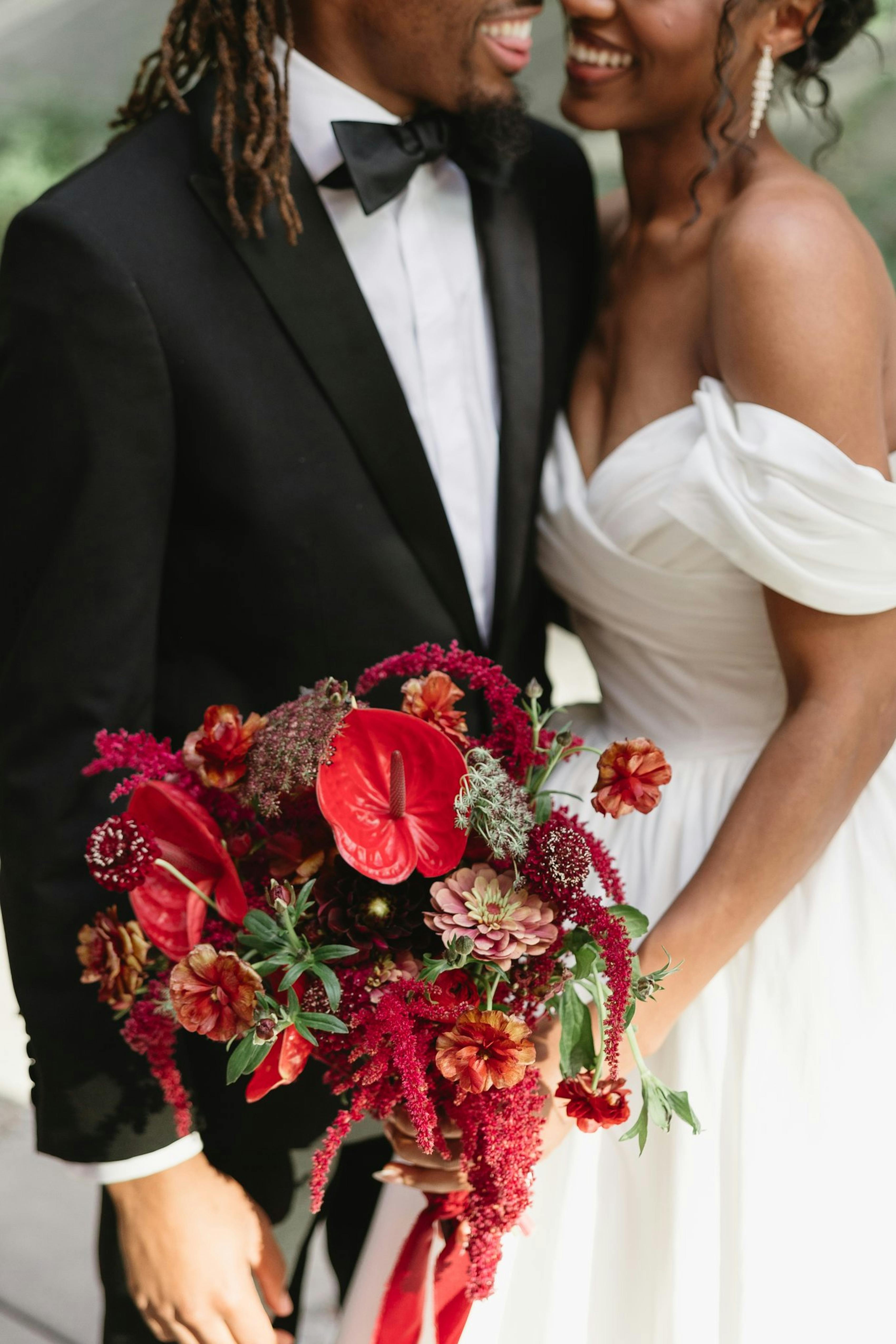 red bouquet for black tie wedding