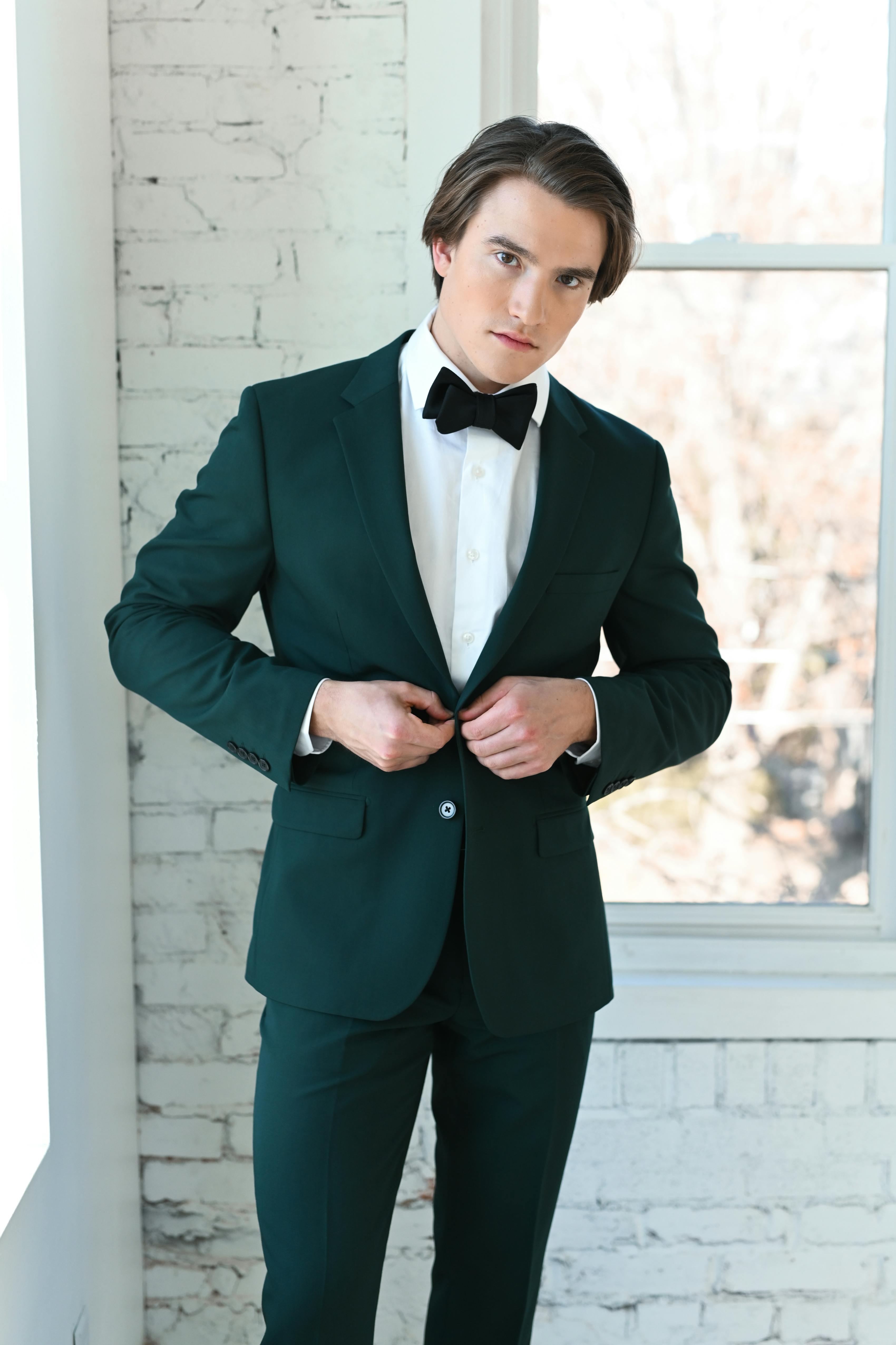 Dark green suit with black bow tie for men's formal winter wedding outfit