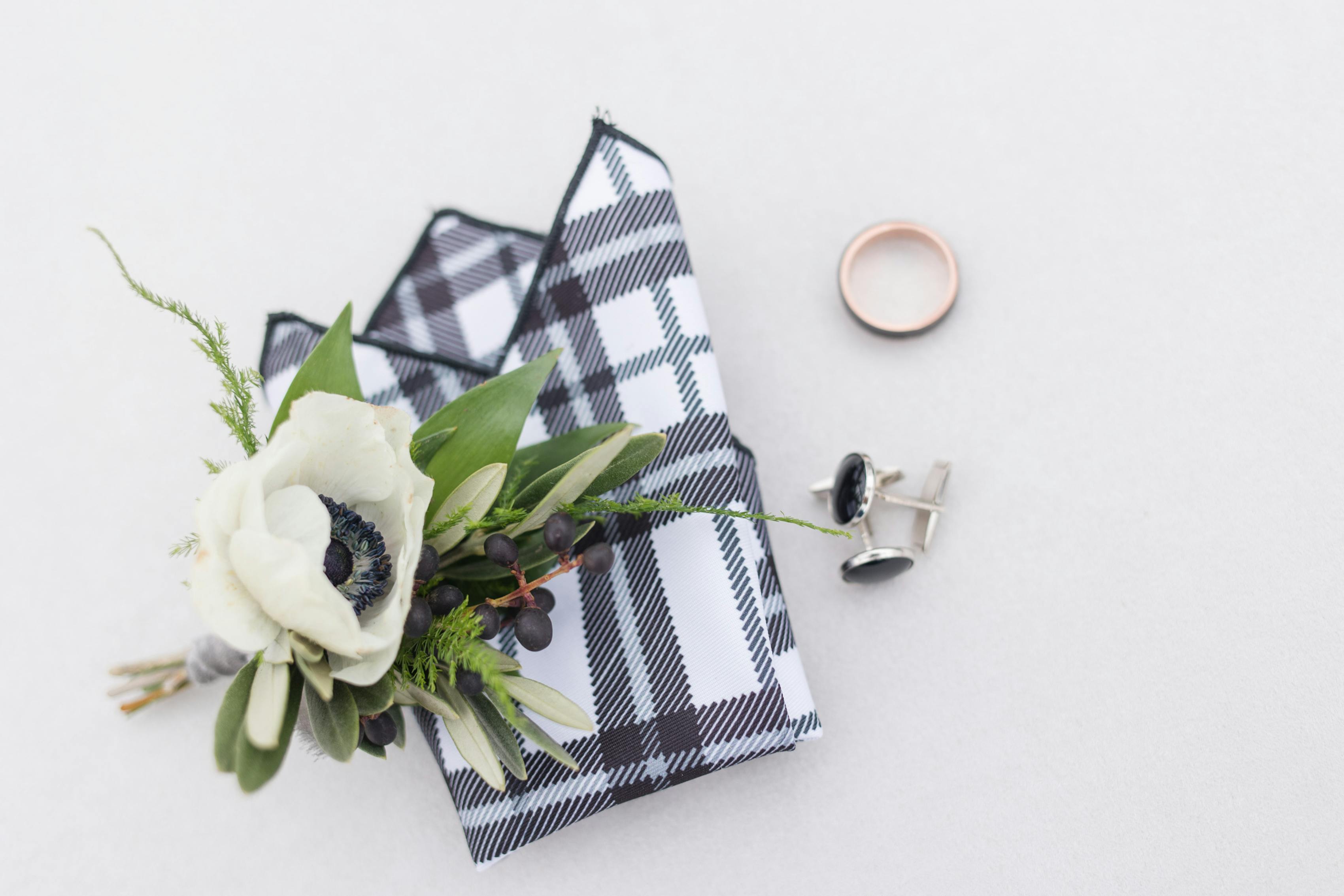 Plaid pocket square and white boutonnière with dried berries for winter wedding