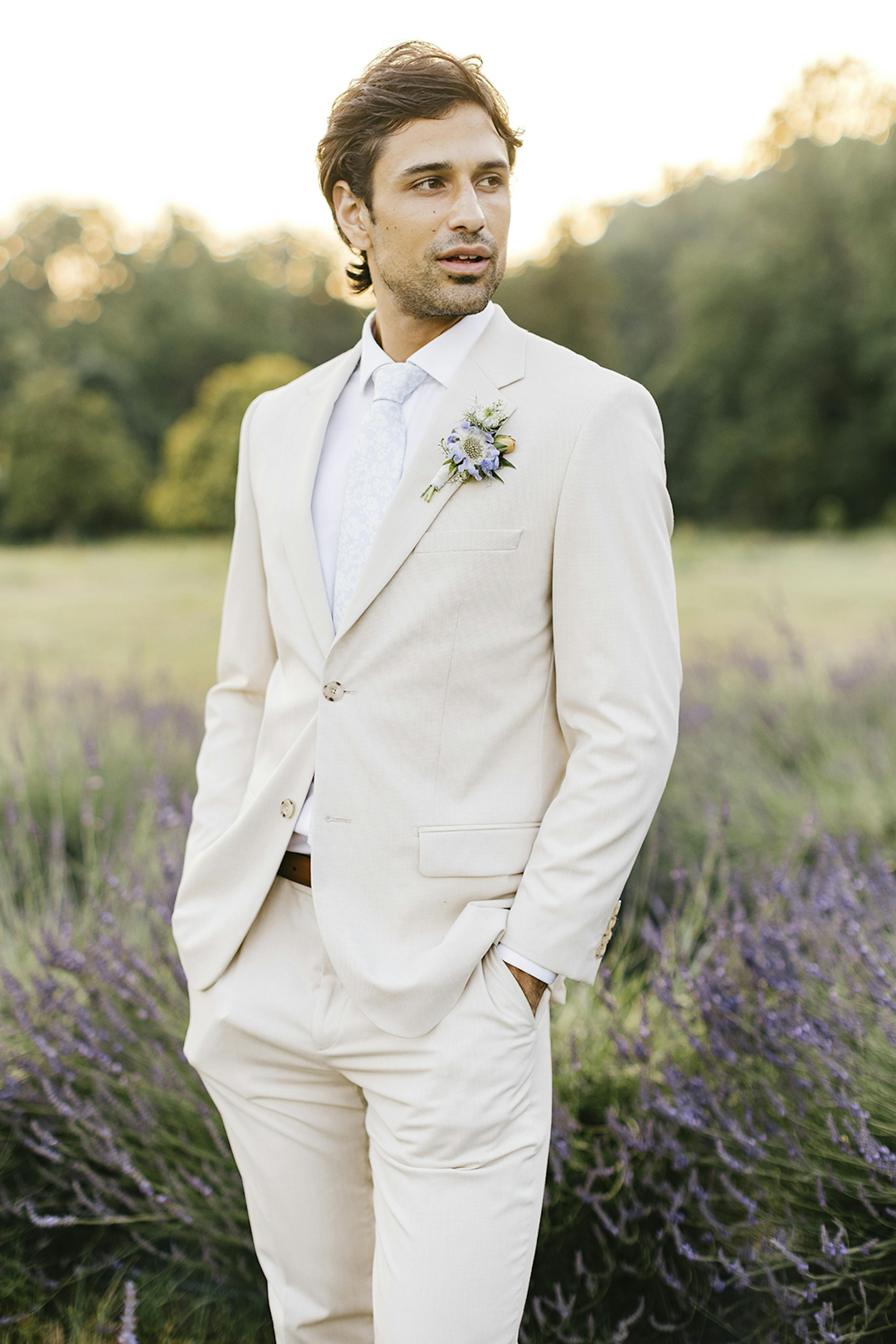 Light tan linen suit at outdoor summer wedding in lavender field