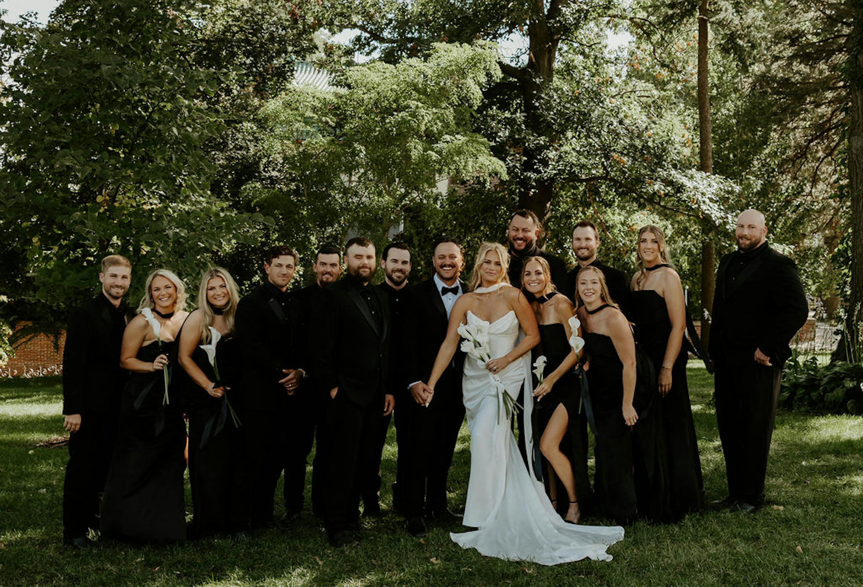 all-black wedding party attire with black bridesmaid dresses & black groomsman suits