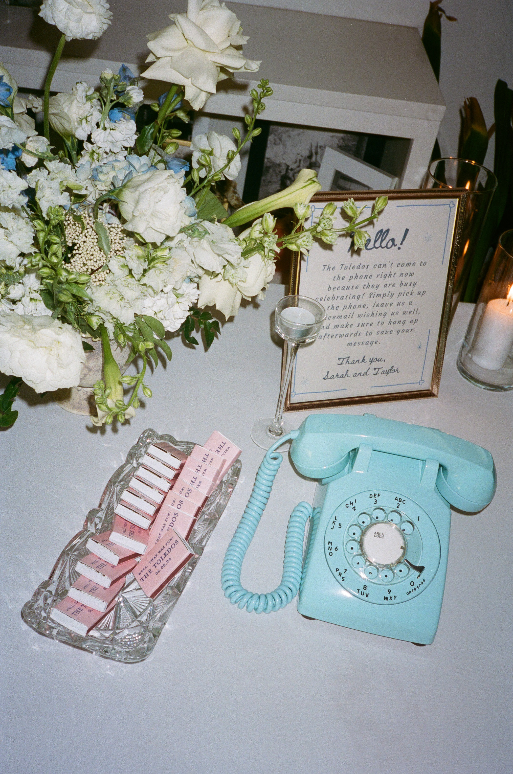 Bright teal vintage telephone at wedding reception for audio guestbook