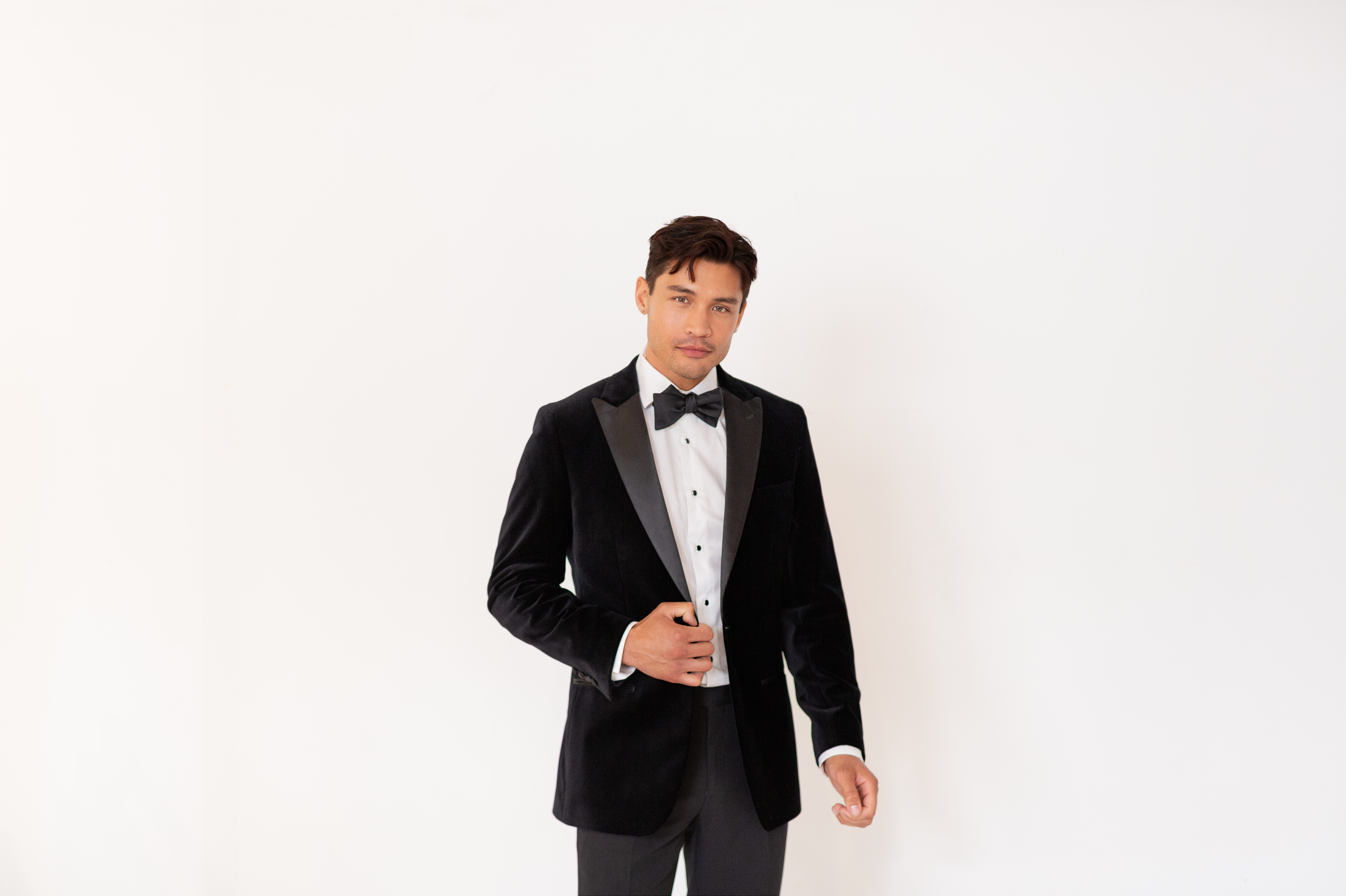 Man wearing shiny black velvet tuxedo
