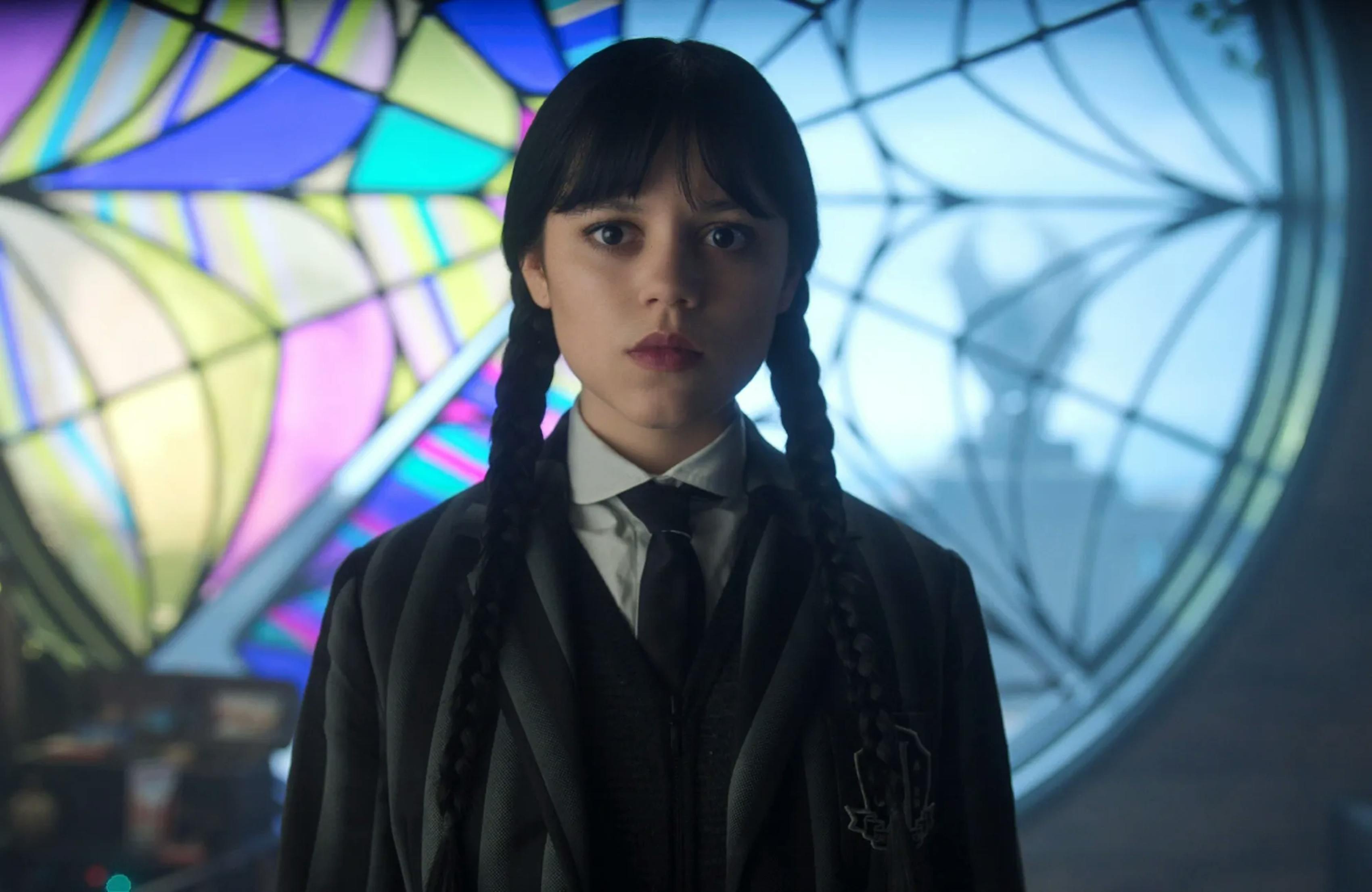 Jenna Ortega as Wednesday Adams in Netflix Season 3 in front of stained glass