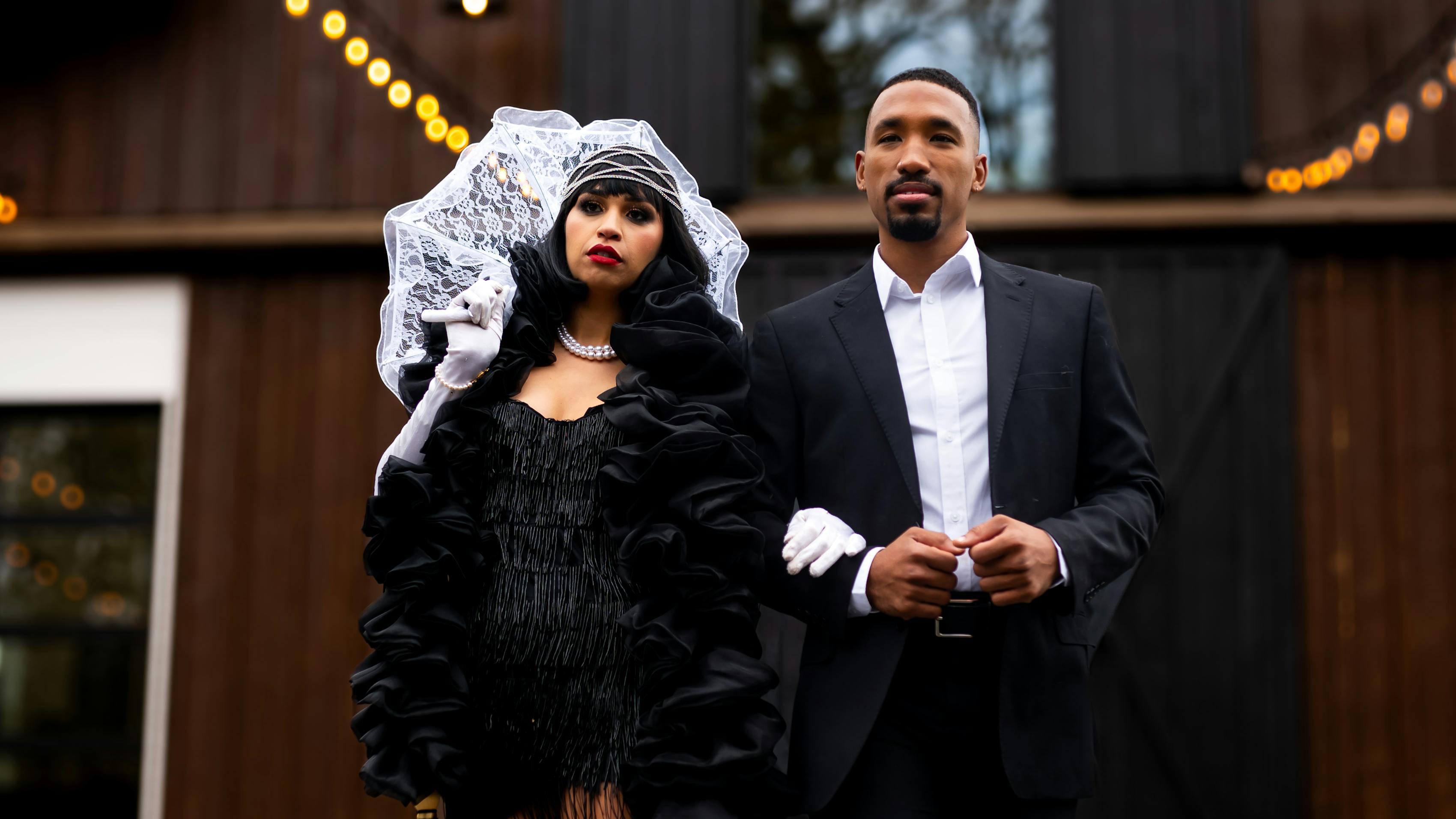 Flapper couples costume with men's black suit and 1920s dress