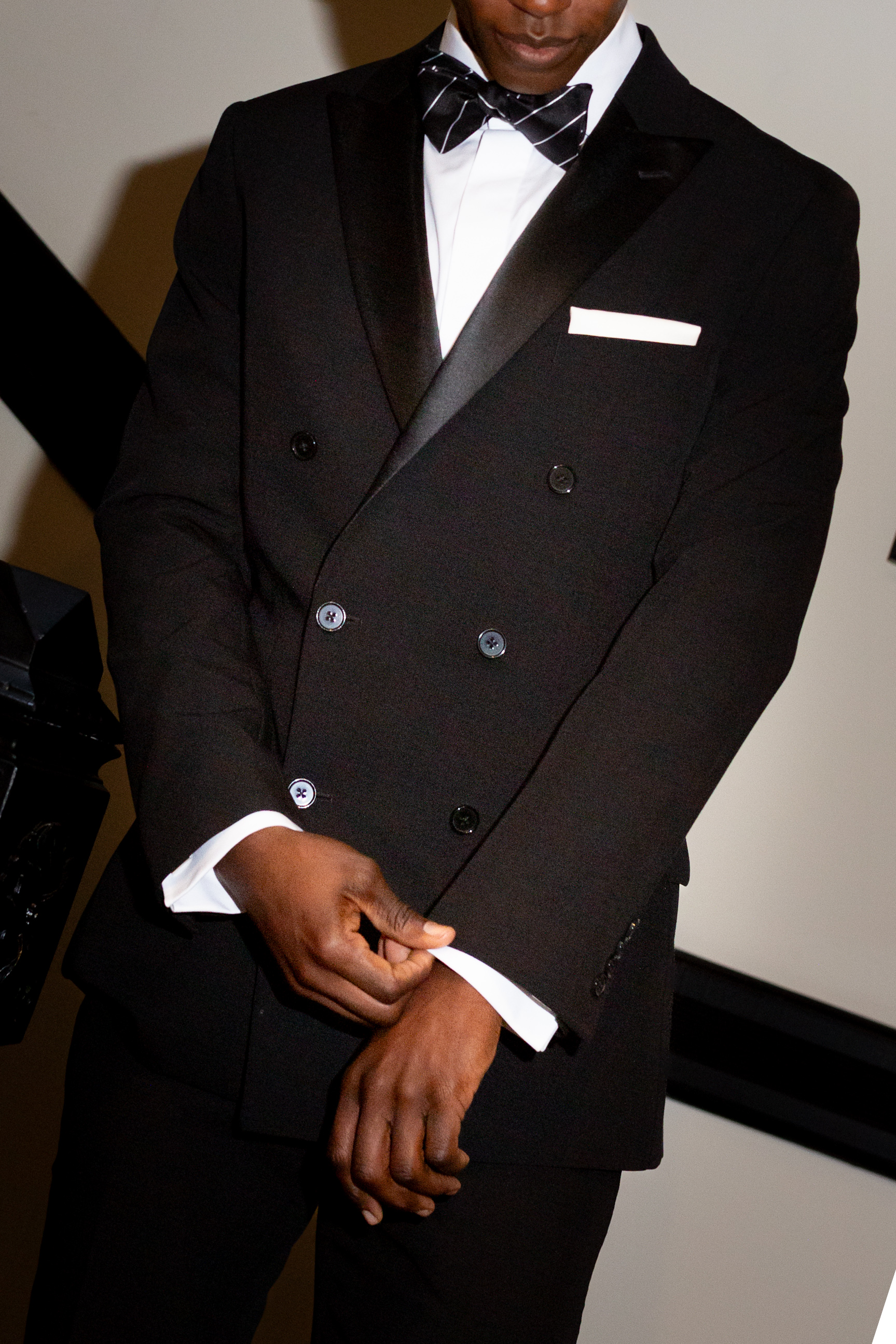 Groom wearing double breasted black tuxedo jacket