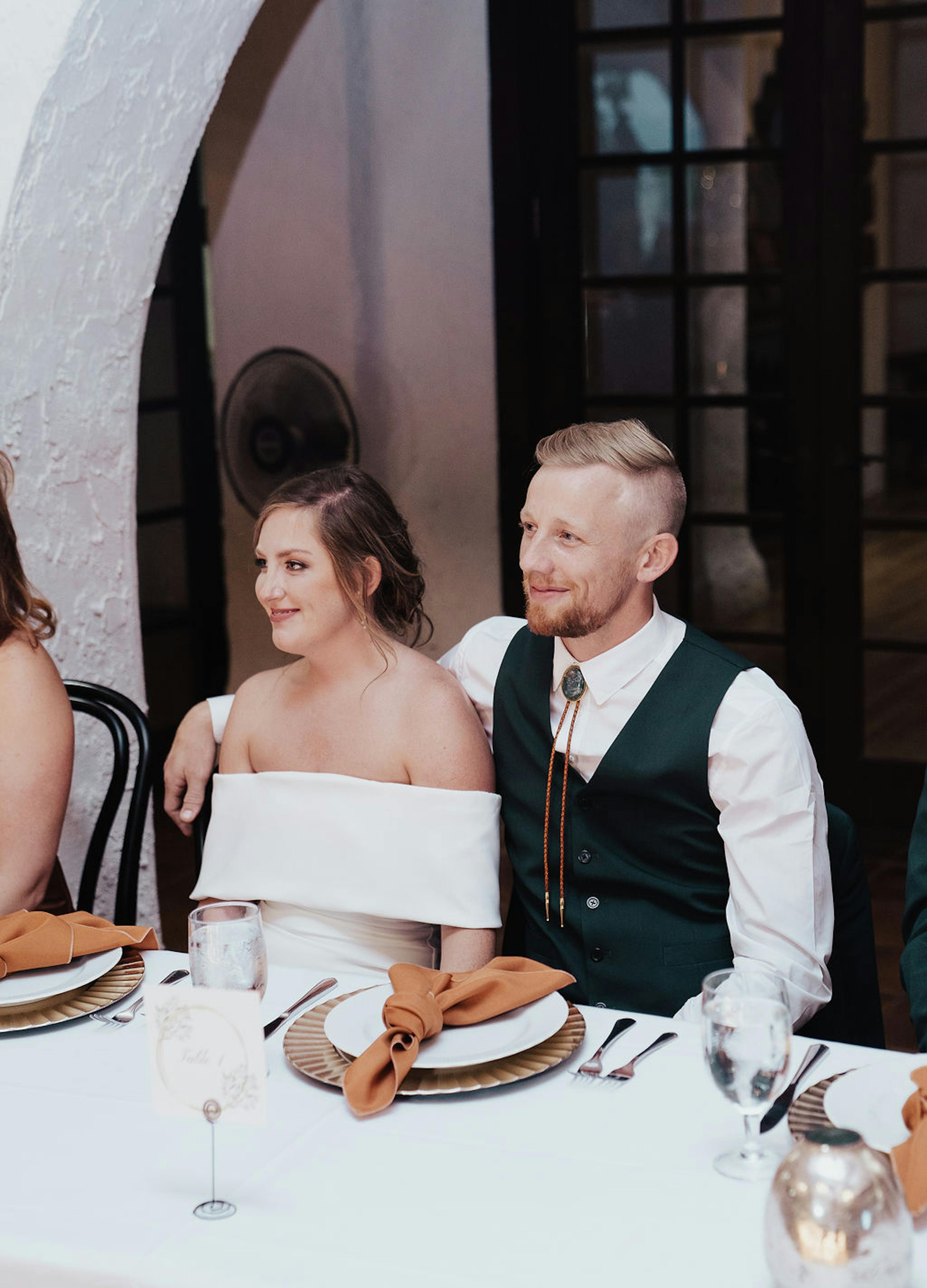 Bride and groom at rehearsal dinner with western wedding theme