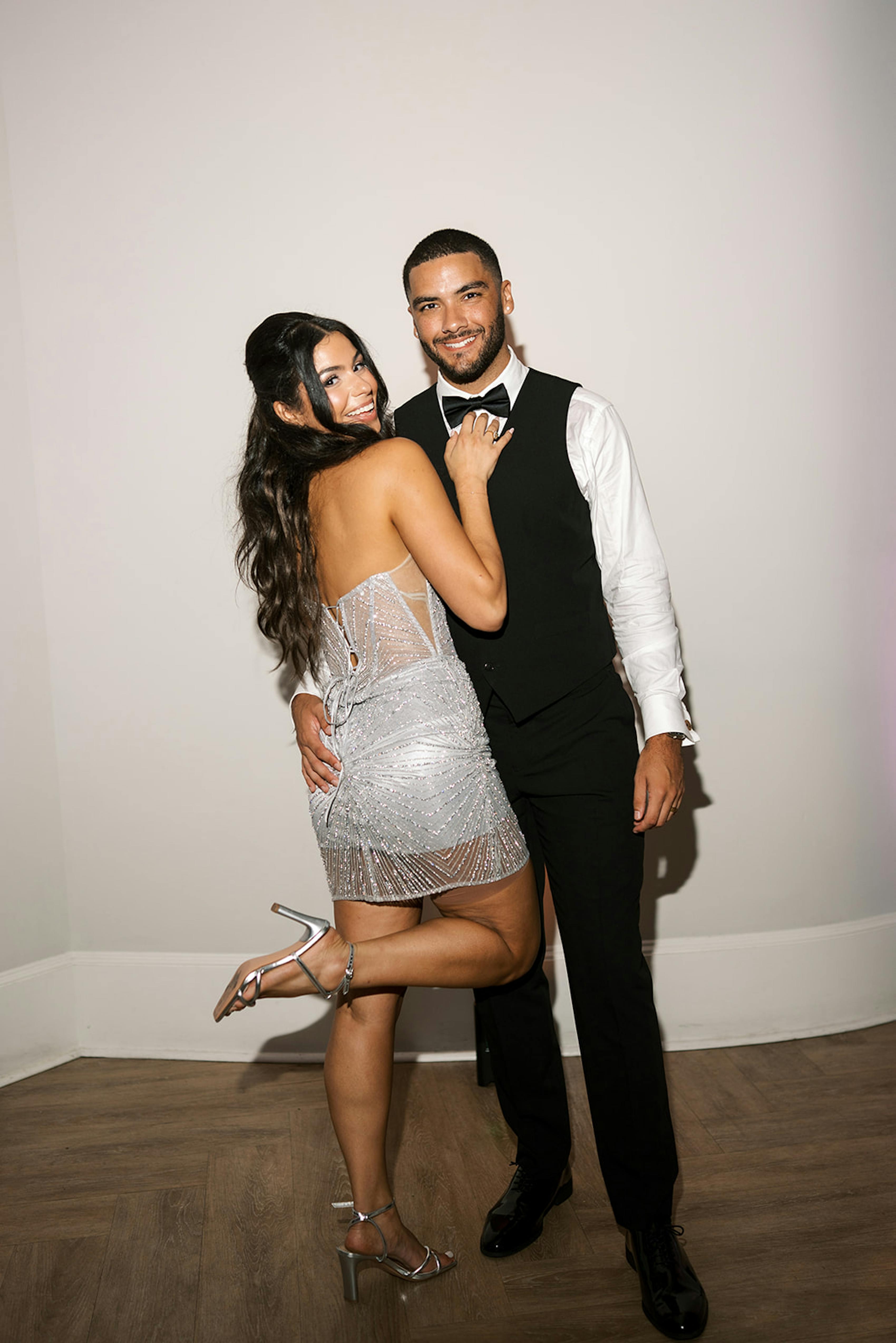 Silver mini dress and tuxedo vest for bride and groom's second look 