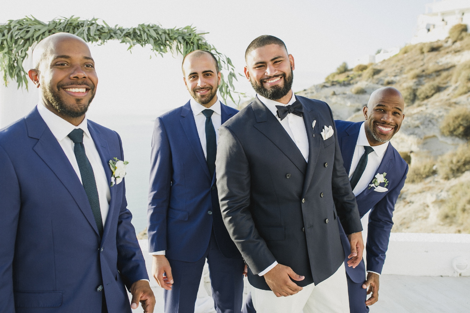 Men wearing navy groomsmen suits at Greece destination wedding