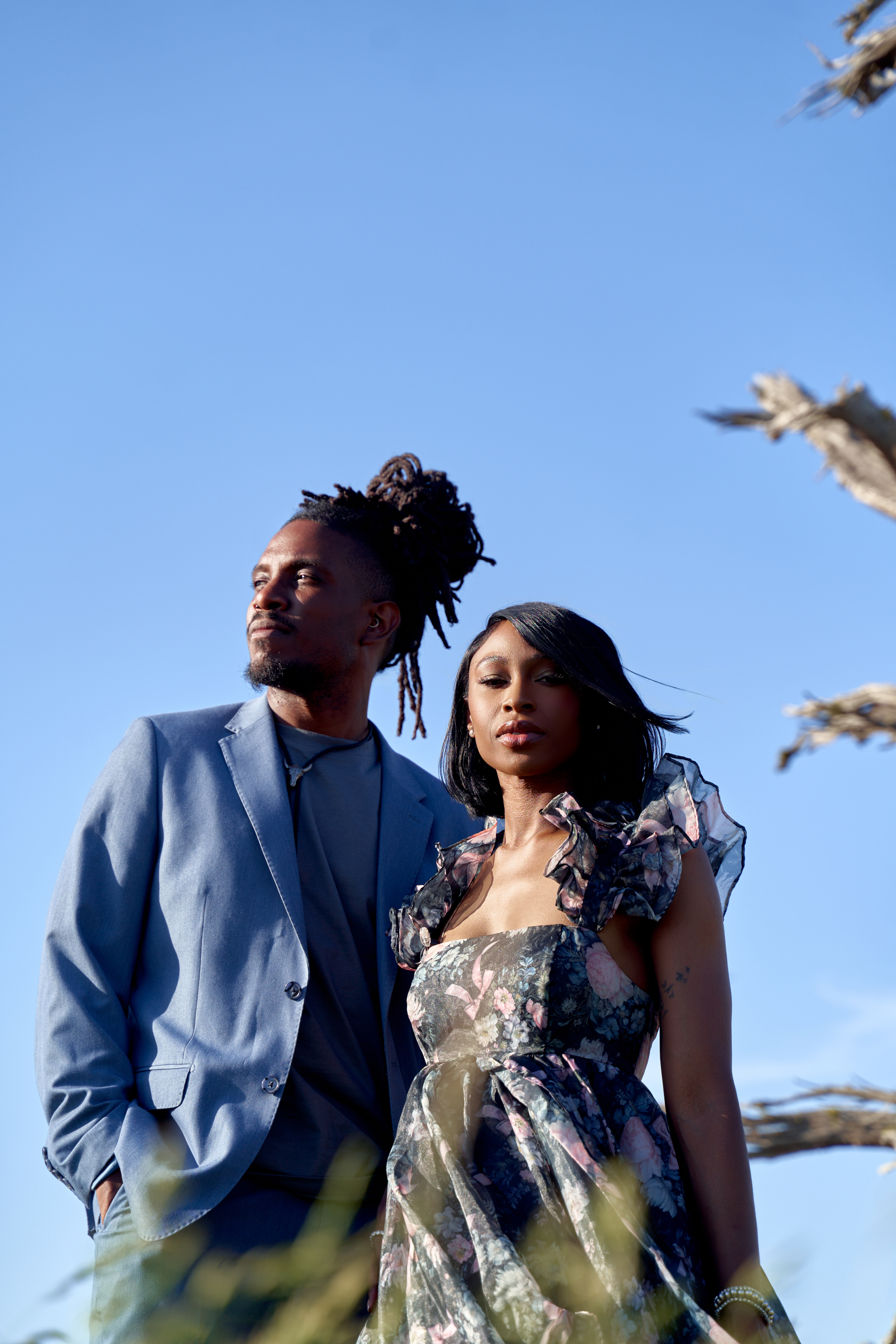 Couple at beach wedding wearing puff sleeve floral dress and monochrome light blue suit