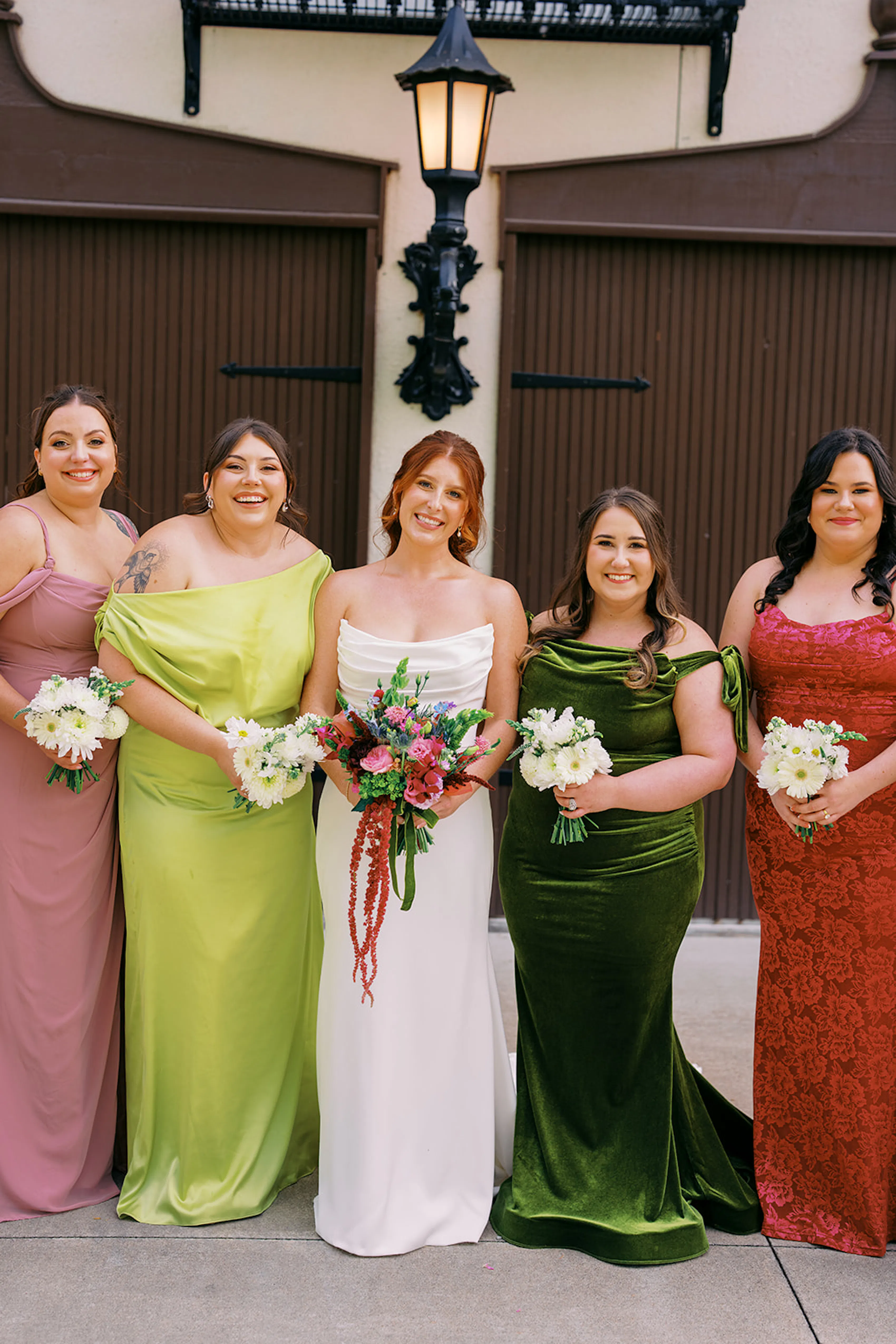 Mix and match bridesmaids in blush pink, chartreuse green, emerald, and fuchsia with bride