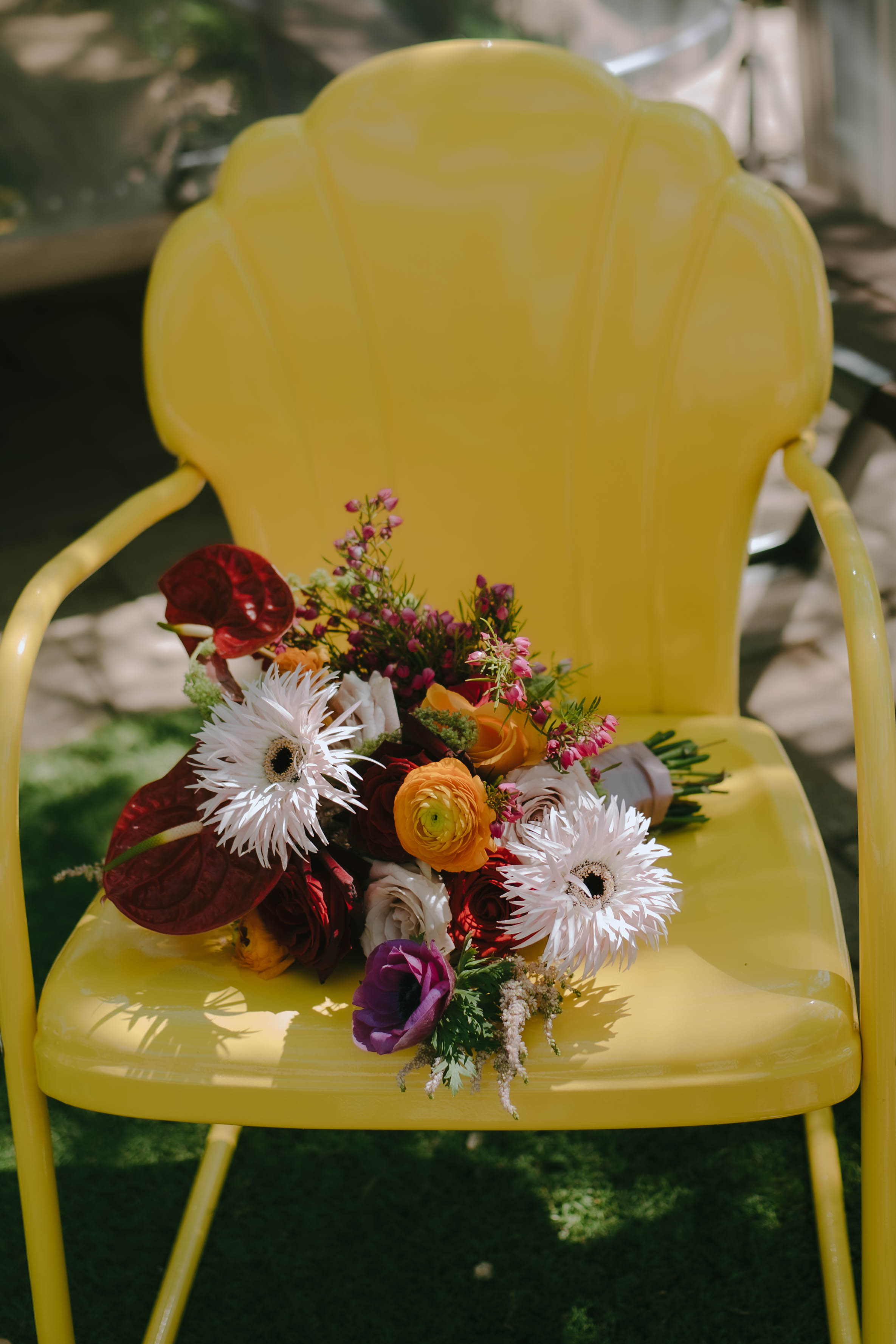 Colorful bridal bouquet on yellow chair for island citrus wedding decor