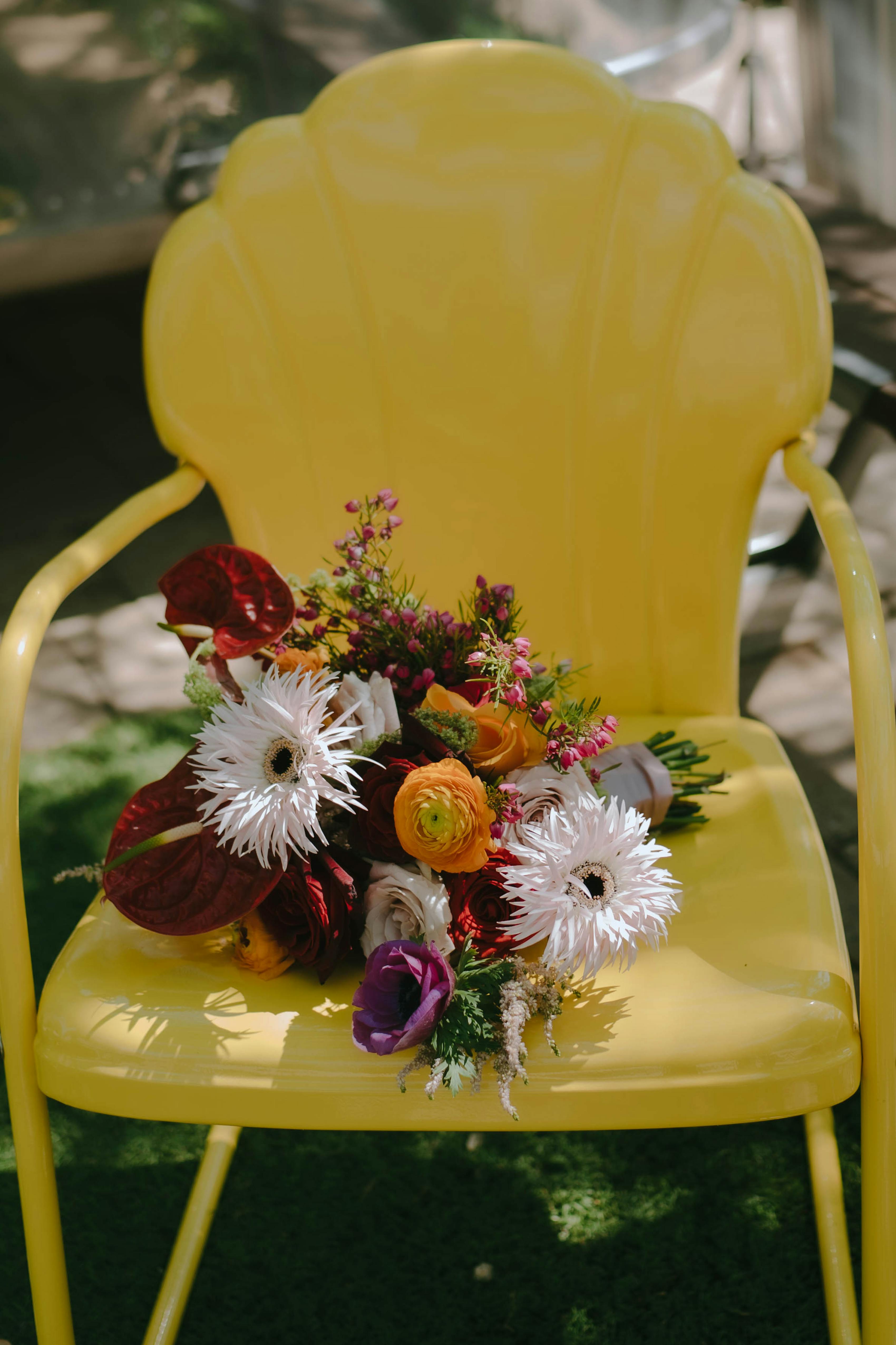Colorful bridal bouquet on yellow chair for island citrus wedding decor