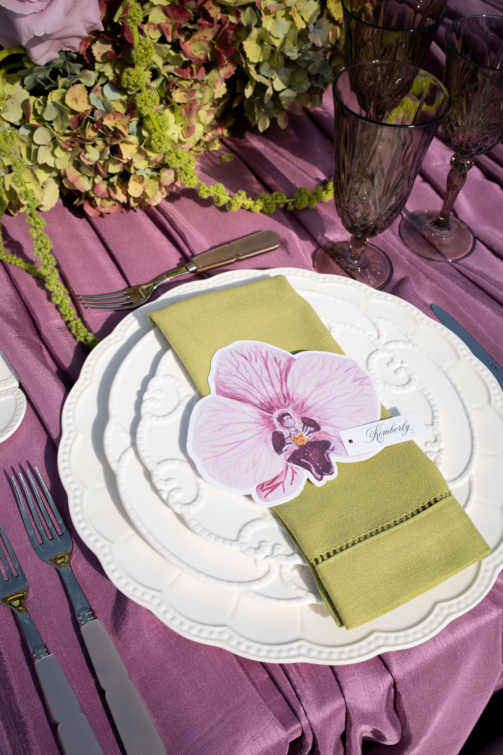 Island citrus wedding tablescape with purple mauve tablecloth and lime napkins and yellow florals