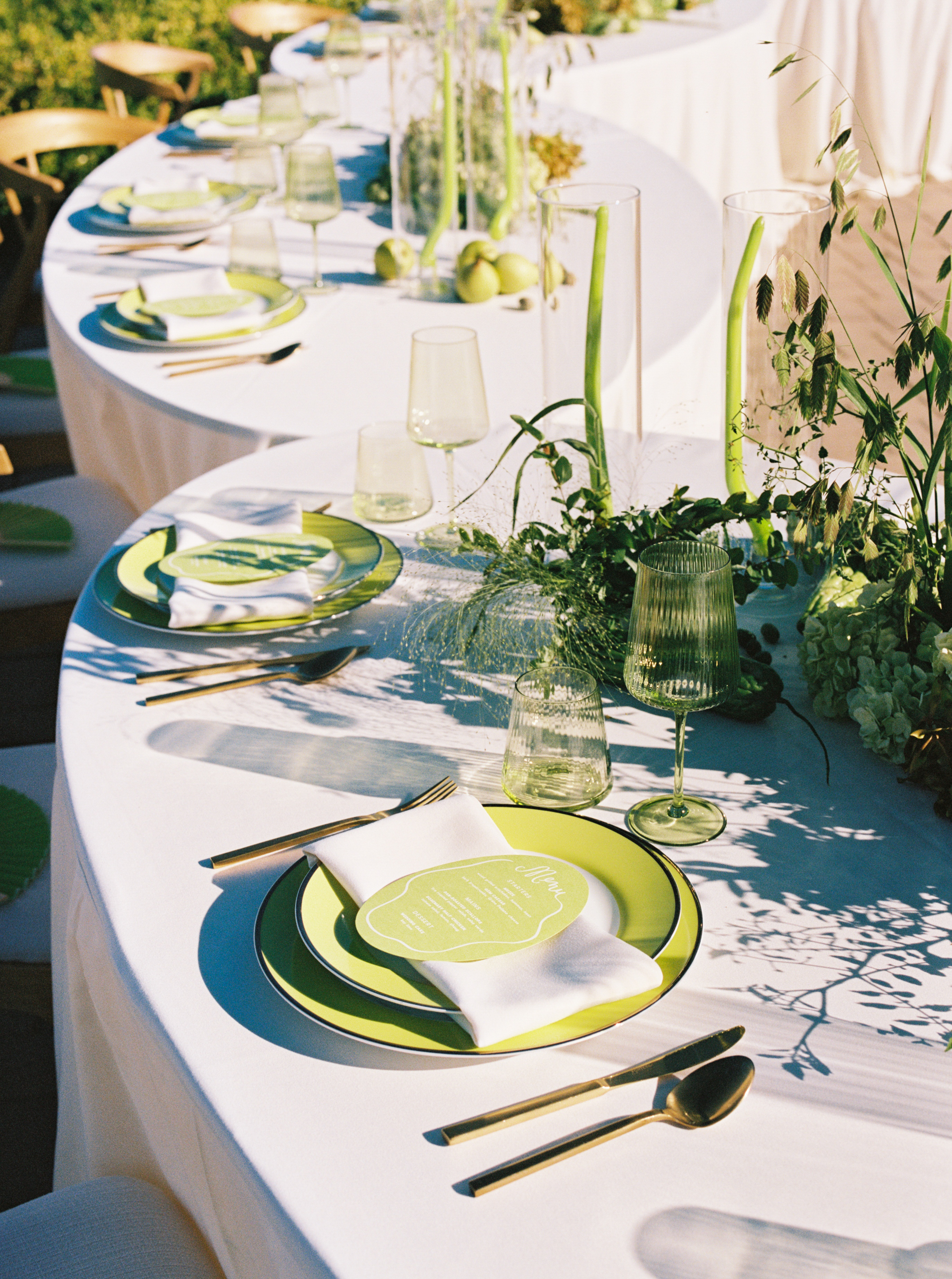 Subtle white and lime green wedding tablescape with large round seating plan