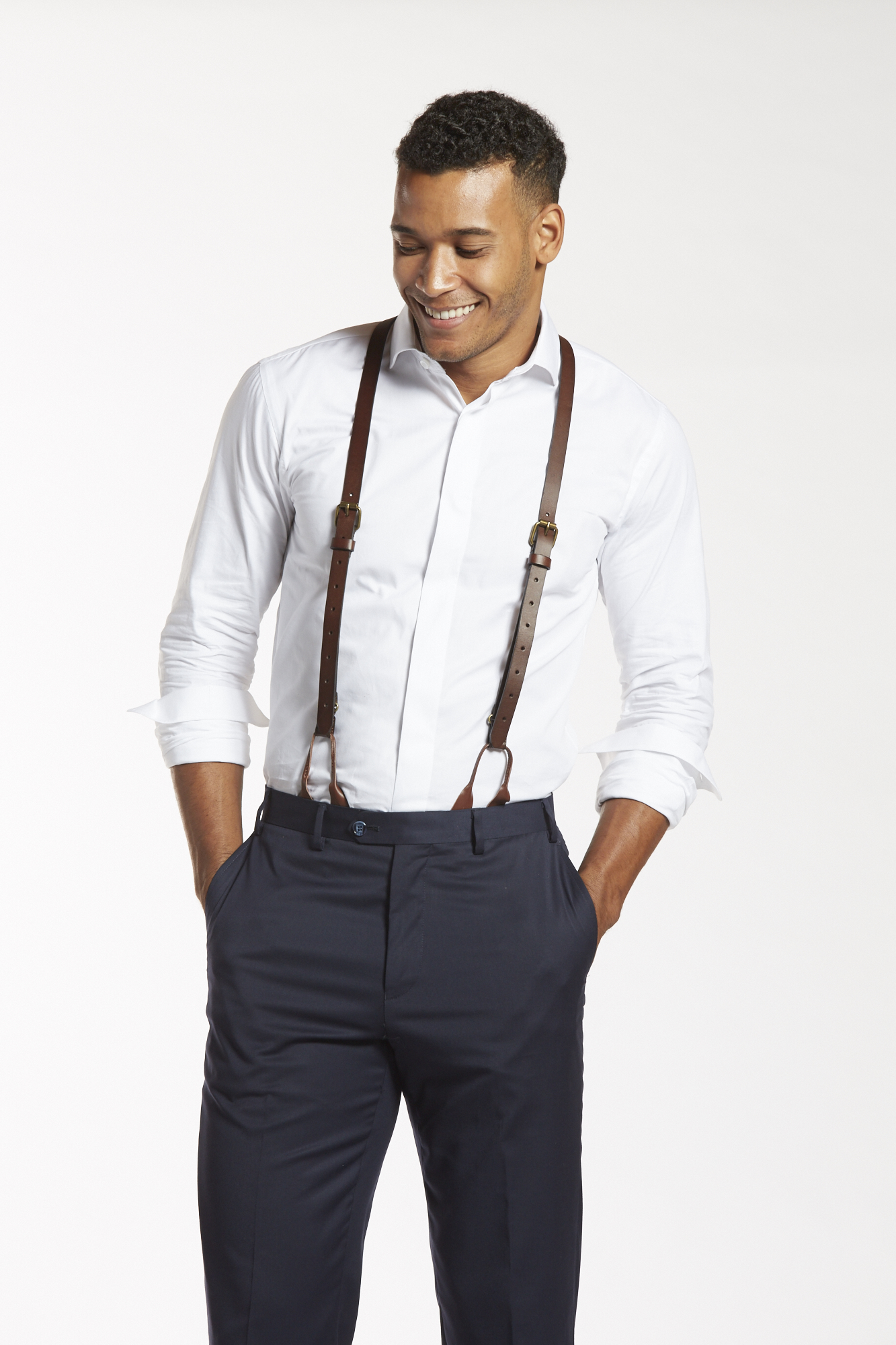 a stylish grooms outfit with navy pants and suspenders light blue shirts  navy bow ties brown shoes  Blue groomsmen Blue groomsmen suits  Groomsmen suspenders