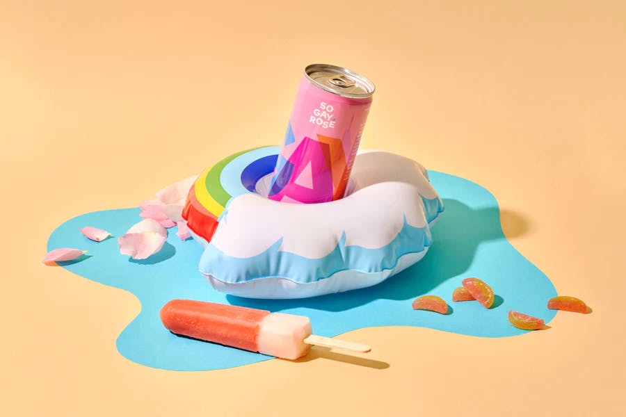 So Gay Rosé canned wine in a Pride-themed rainbow pool float.
