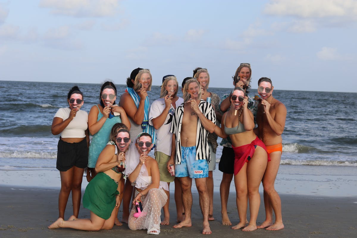 wedding party at their mix gendered bacherlorx party at the beach in Tybee Island, Ga