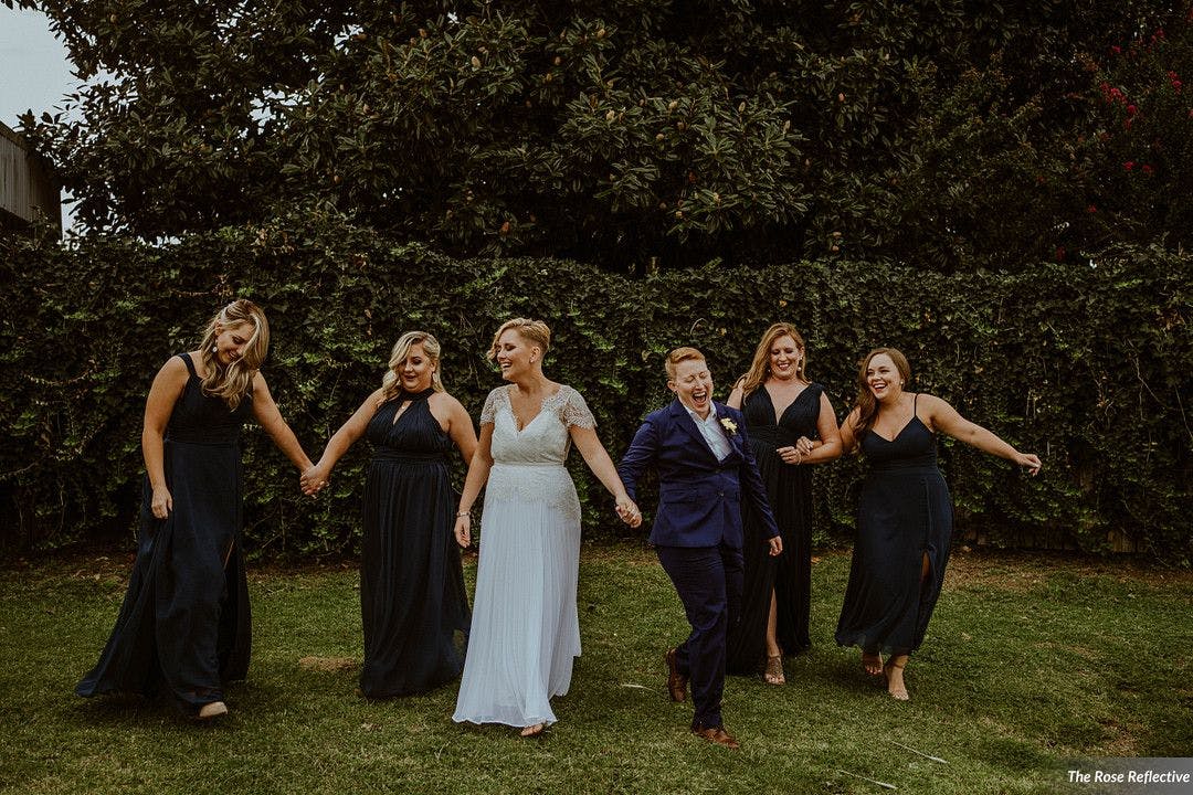 The full bridal party shares a wedding dance together as an alternative to the father-daughter dance.