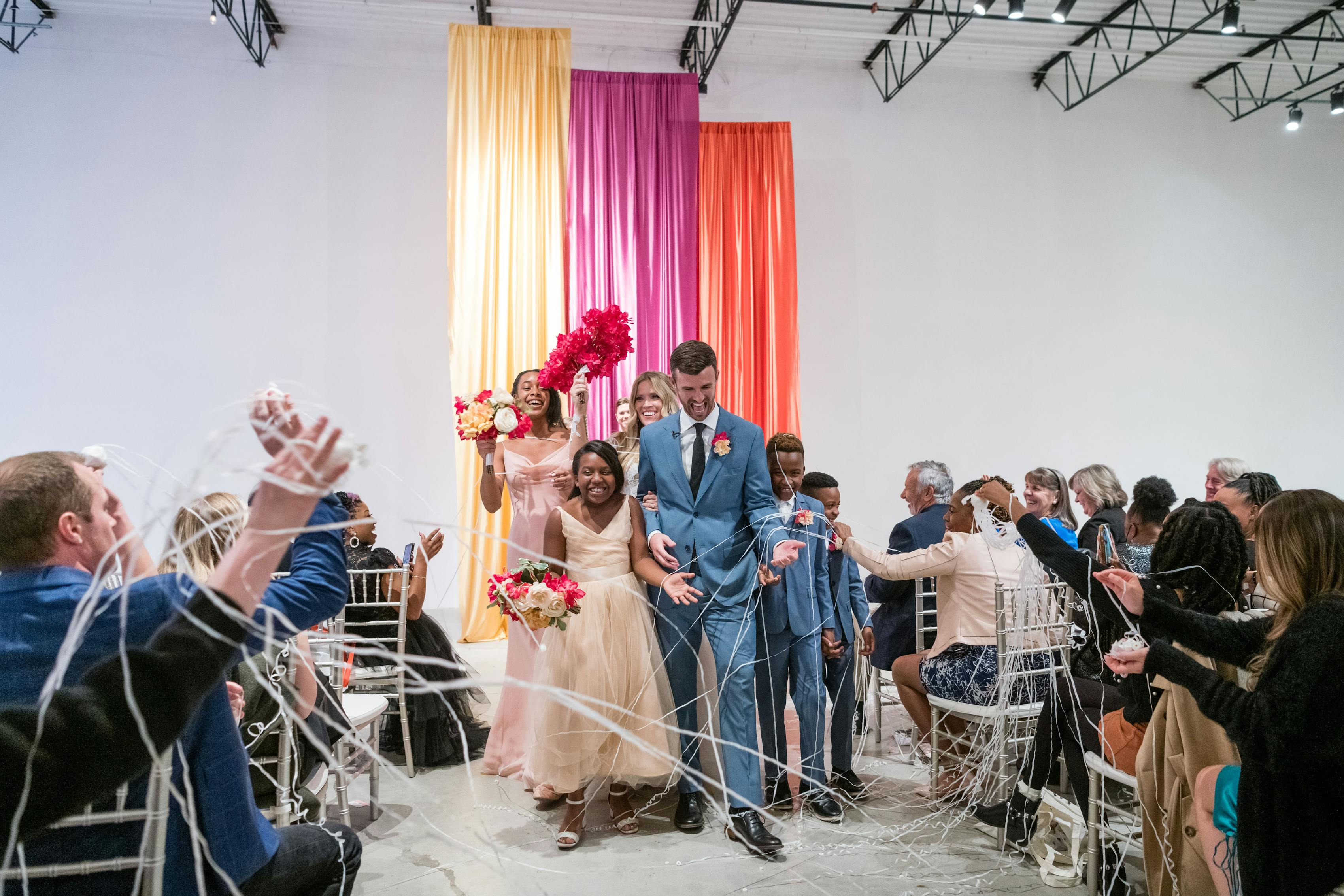 Light blue suits for Alice in Wonderland themed vow renewal wedding ceremony to include the couple's children.