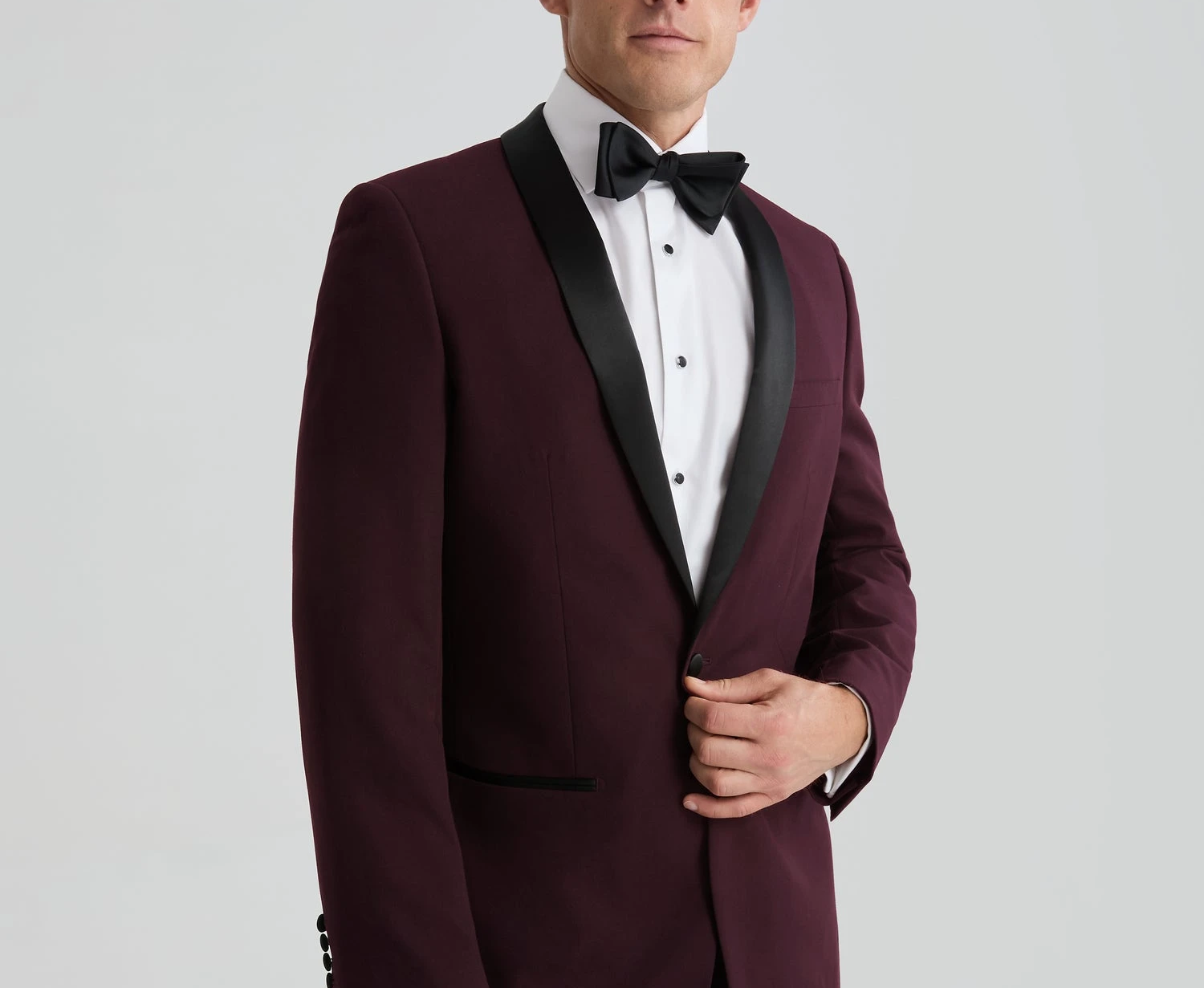 Burgundy tuxedo with black lapels and black bow tie for a formal wedding or black tie event.