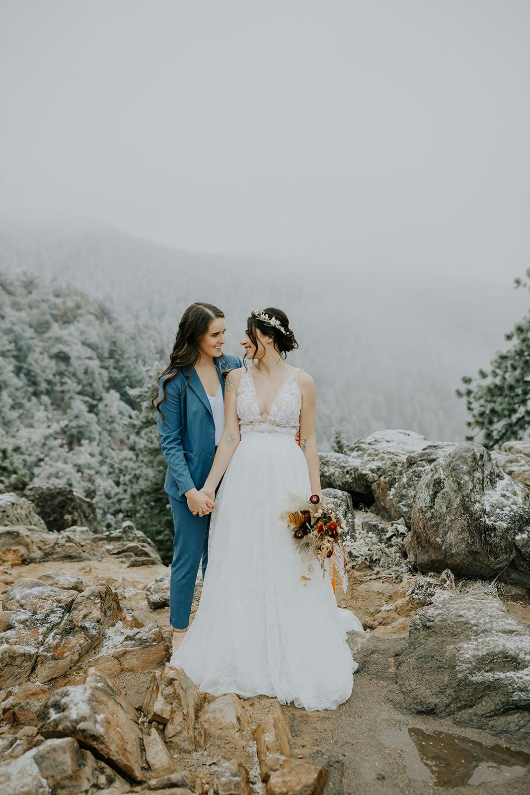 Bride in women's light blue suit for mountaintop wedding, an alternative wedding venue.