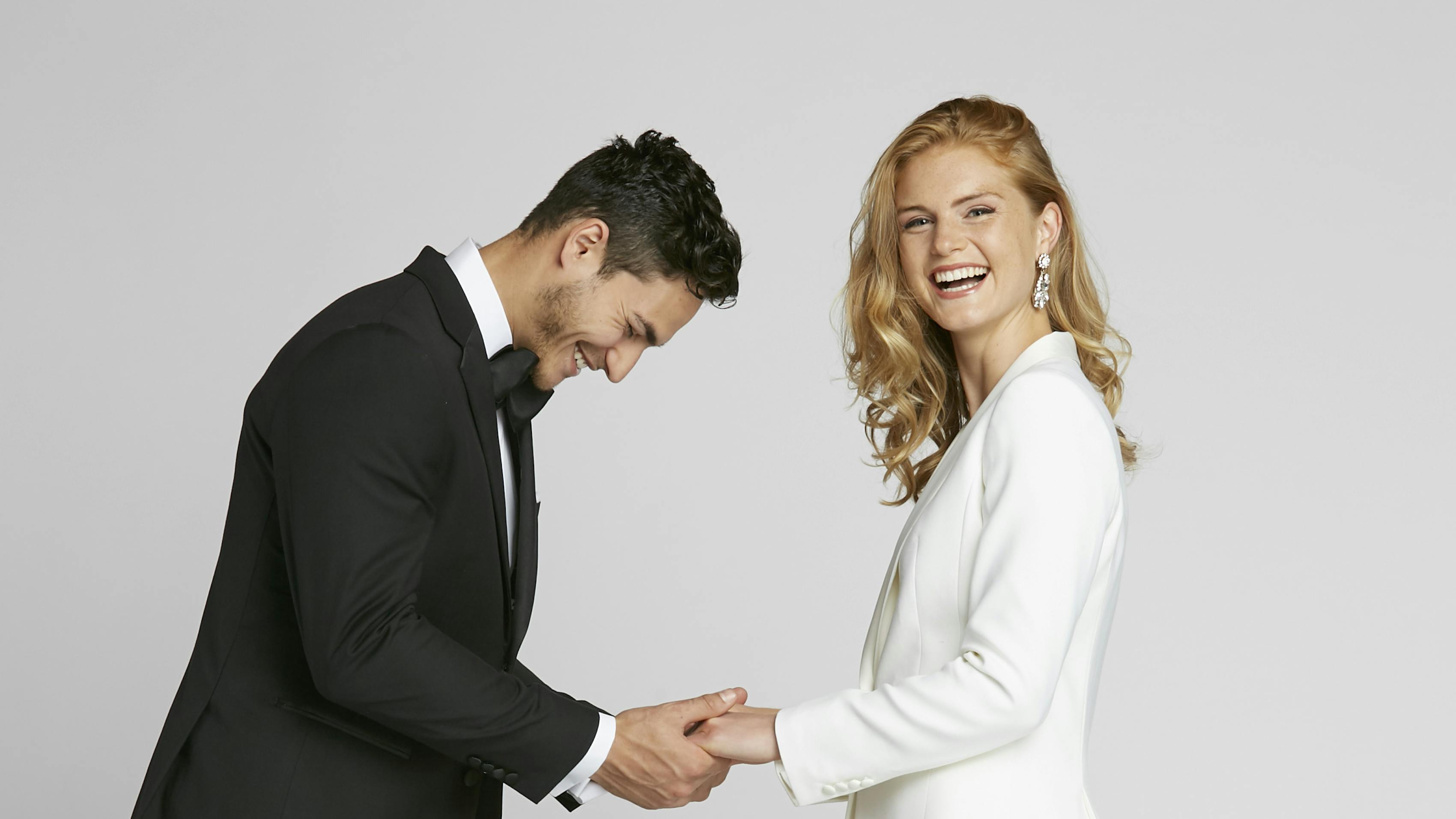 Guide on what to wear to a rehearsal dinner. Instead of a white rehearsal dinner dress, try a white women’s tuxedo.