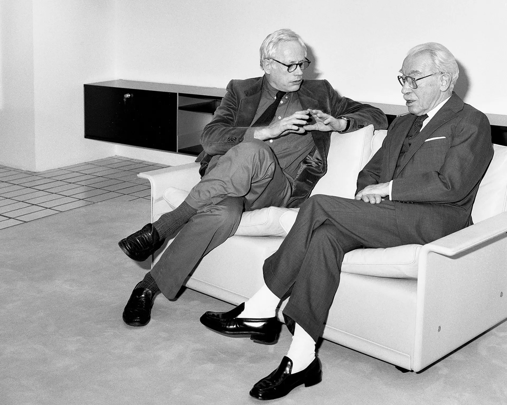 Dieter Rams and Niels Vitsœ sit together on a Vitsœ 620 armchair circa 1975.