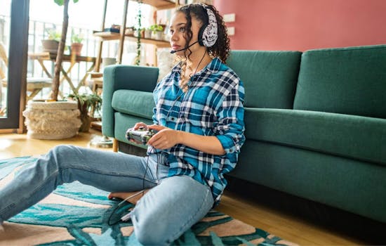 Young woman at home playing playstation