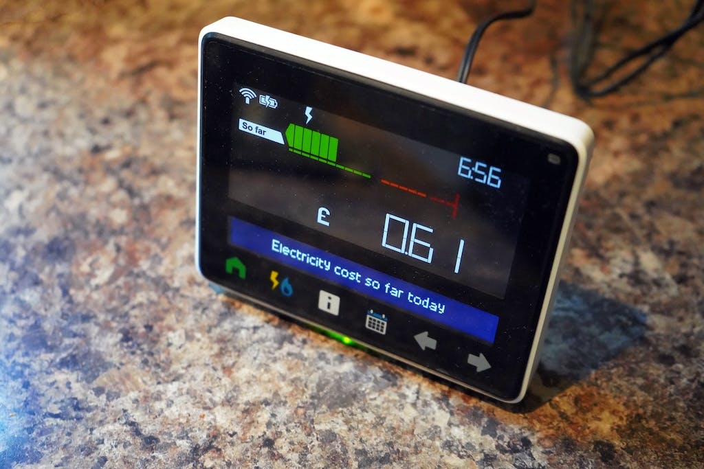 A smart meter's digital display screen on a kitchen worktop