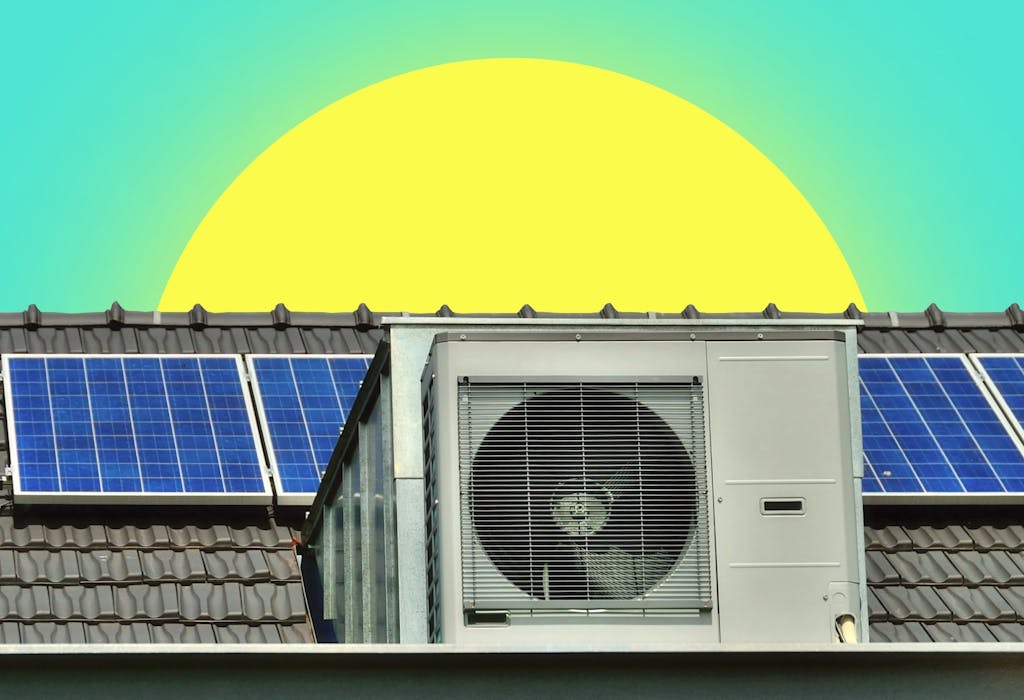 A heat pump and solar panels on a grey roof under a sun and an aquamarine sky