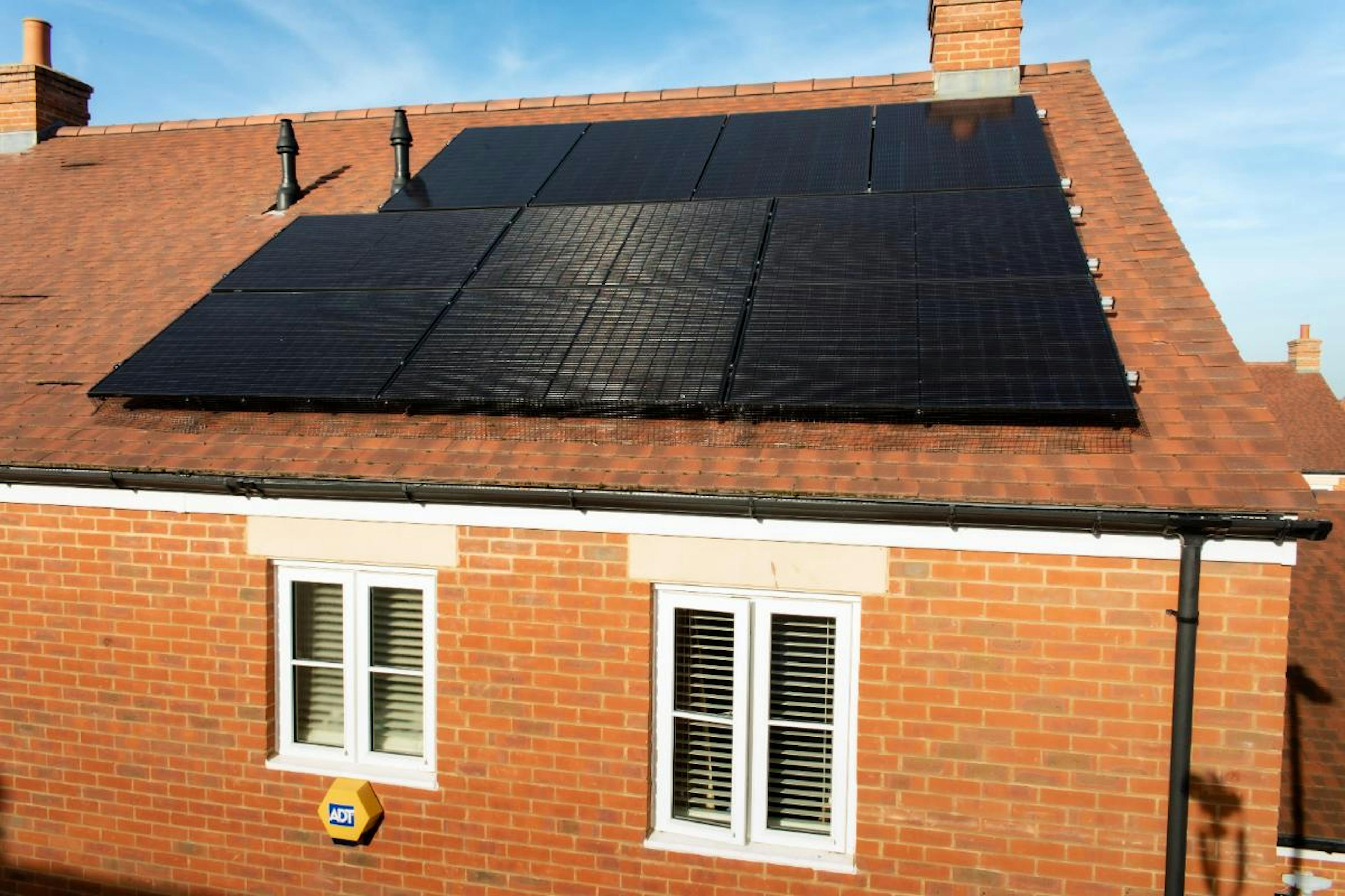 A photo of a house with a 10-panel solar system