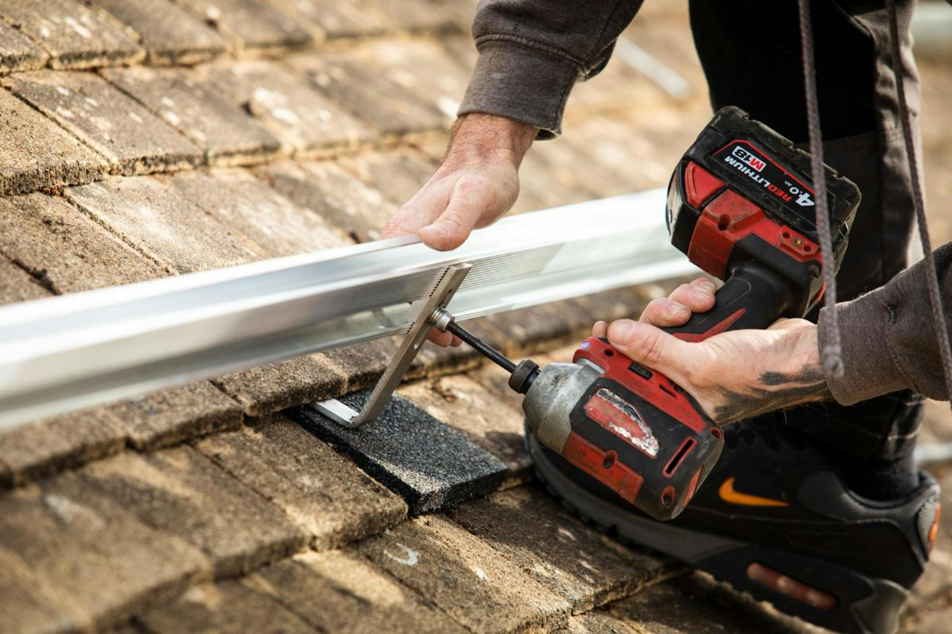 A photo of a solar panel frame being drilled