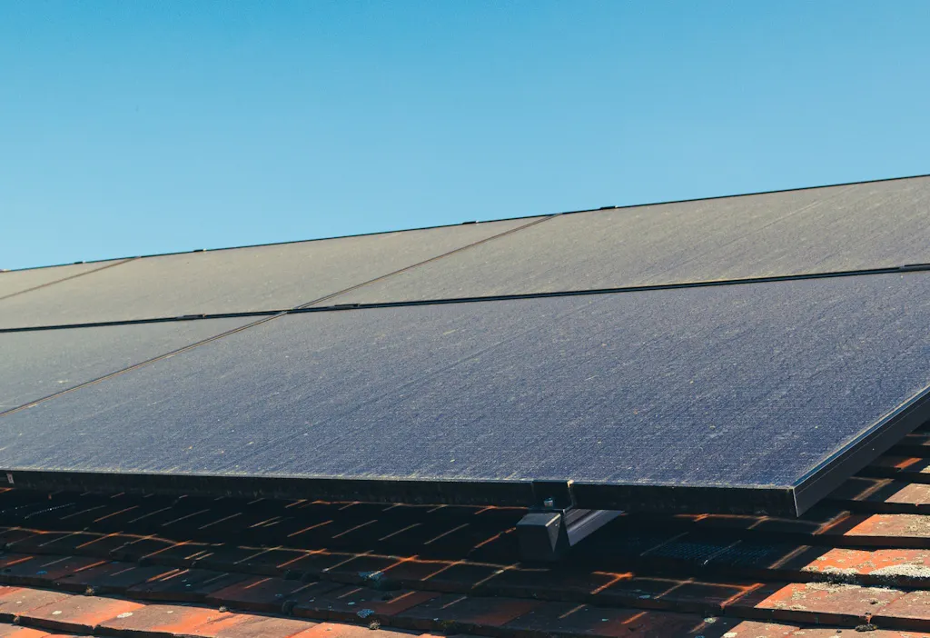dusty black solar panels on a terracotta roof