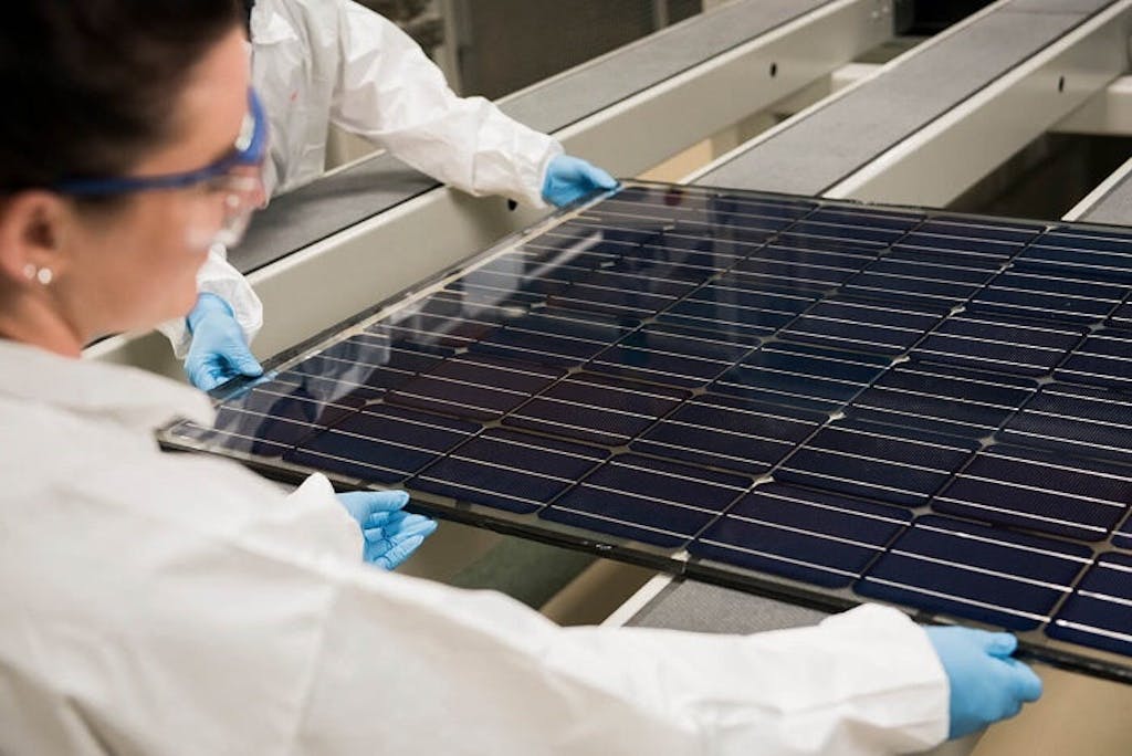 Scientist holding a perovskite-silicon tandem solar module (Oxford PV)